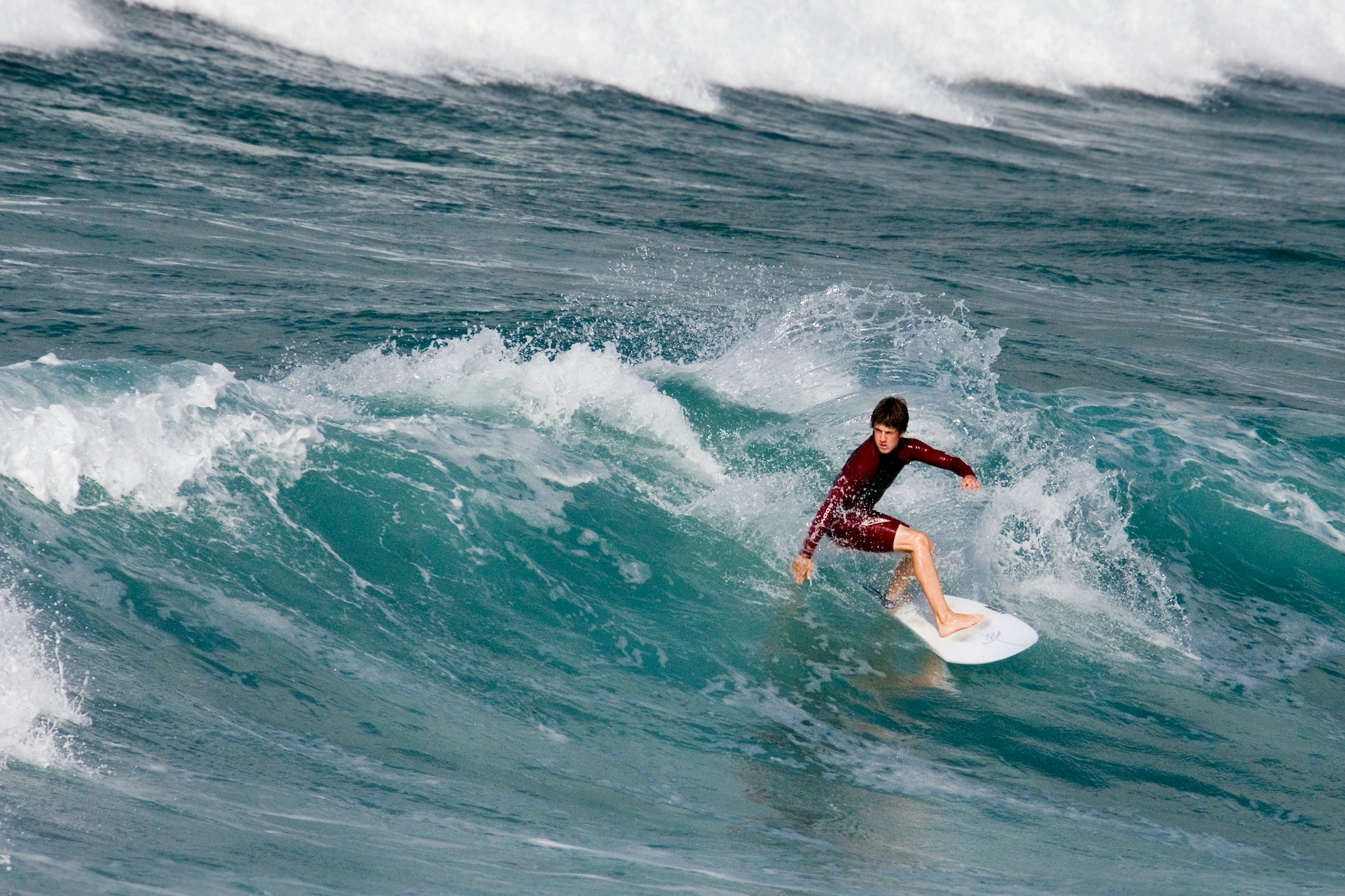 A surfer off Fistral Beach in Newquay in Cornwall, United Kingdom.