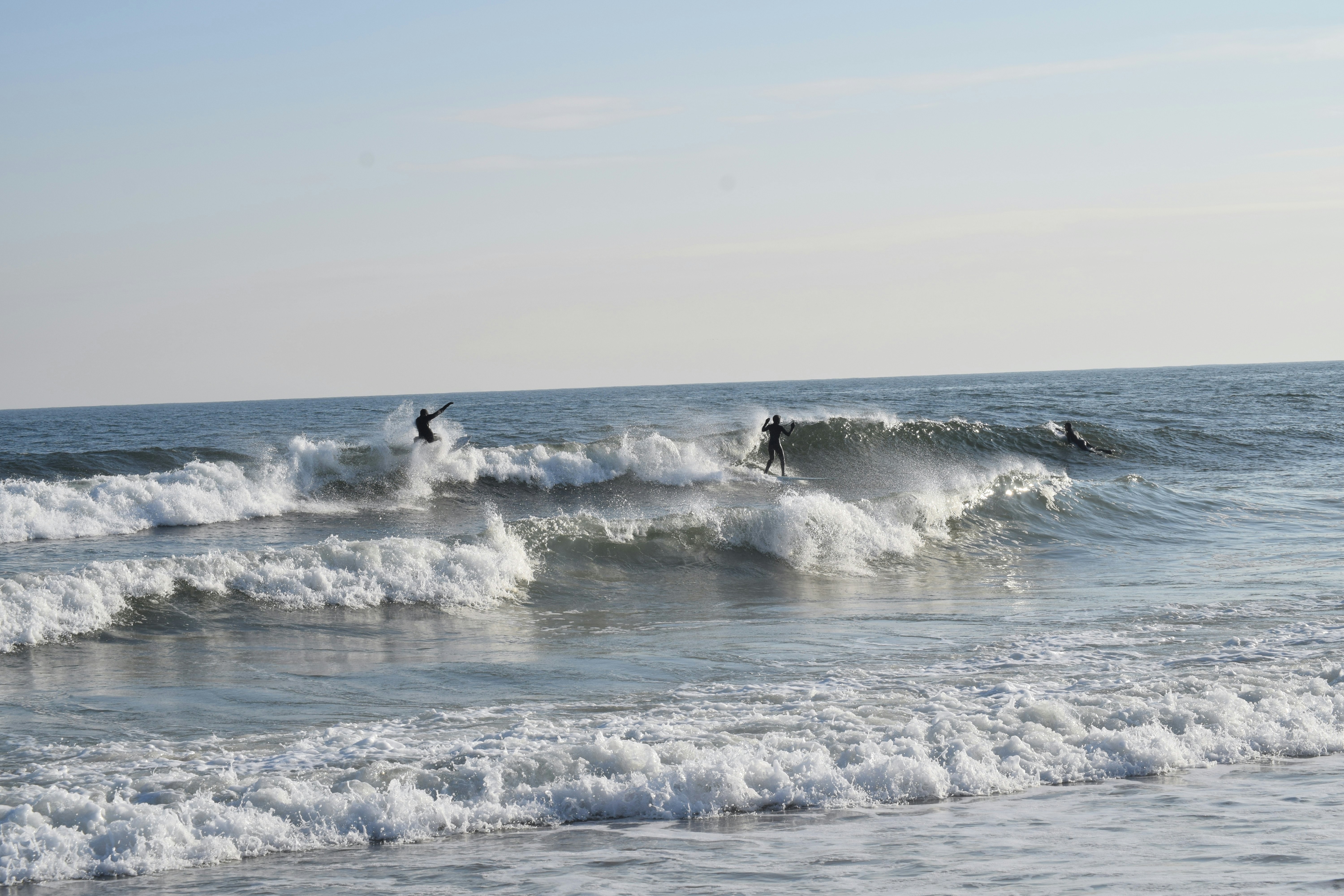 3 surfers at Rockaway Beach