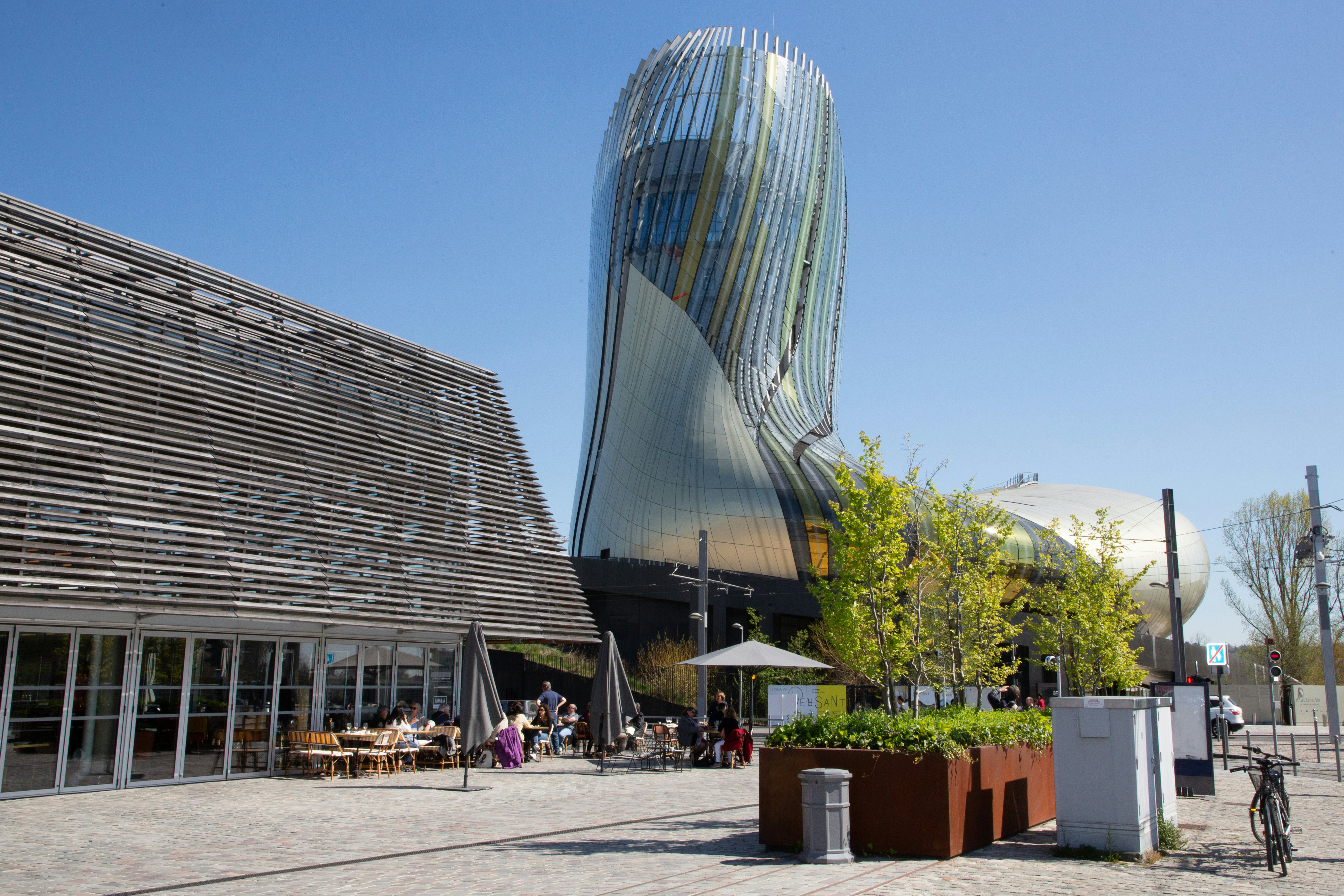 The exterior of a modern museum building with a large glass and steel form resembling a wine decanter.