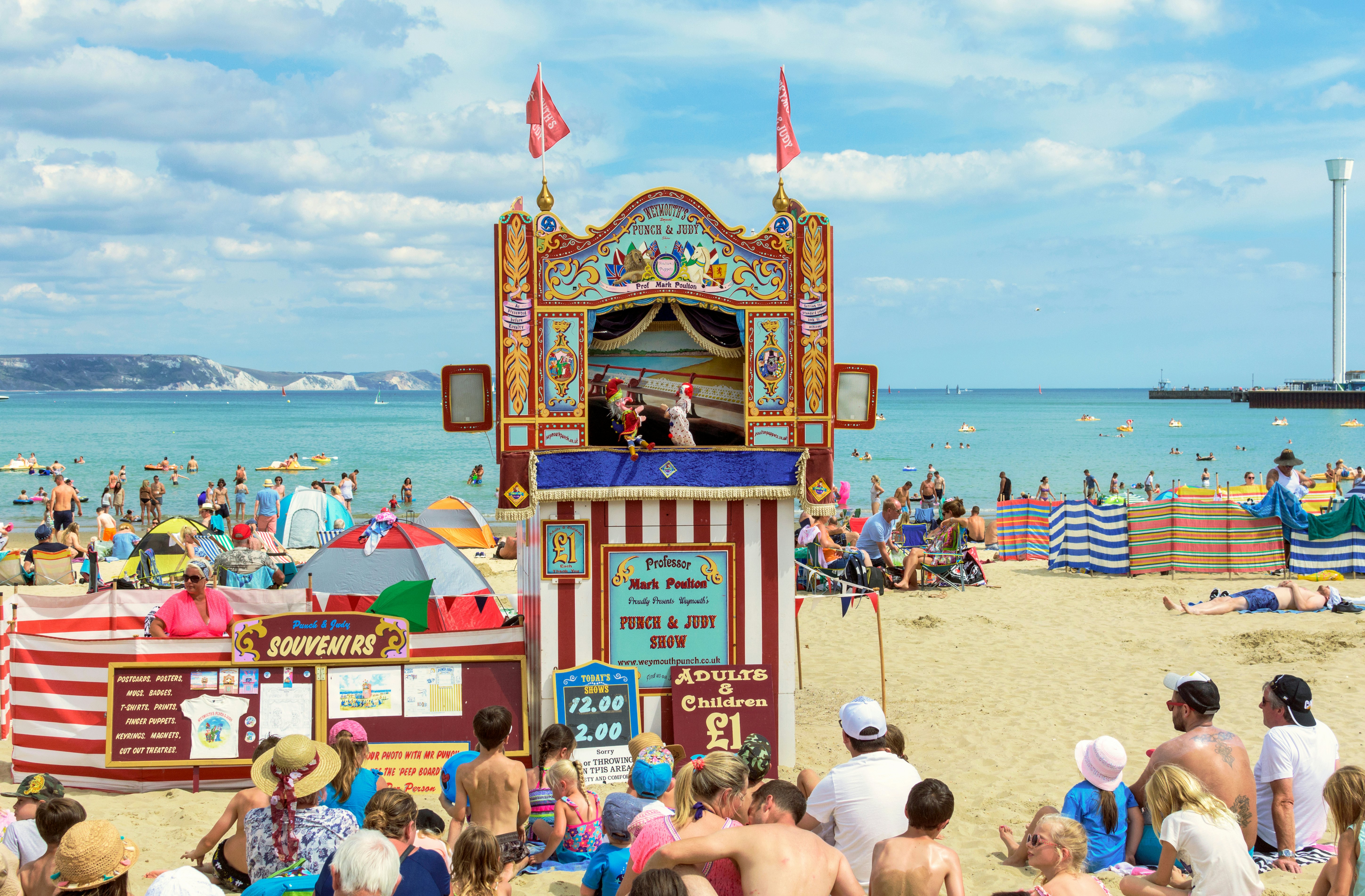 Punch and Judy show on crowded beach at Weymouth, England.
