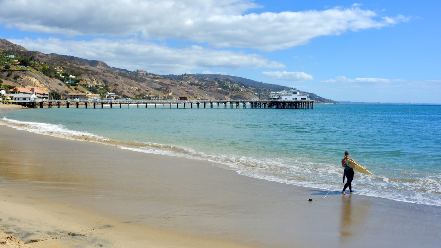 female Surfer heading to the ocean Malibu Beach California License Type: media Download Time: 2023-10-05T13:41:34.000Z User: nic.dhoedt_lonelyplanet Is Editorial: No purchase_order: