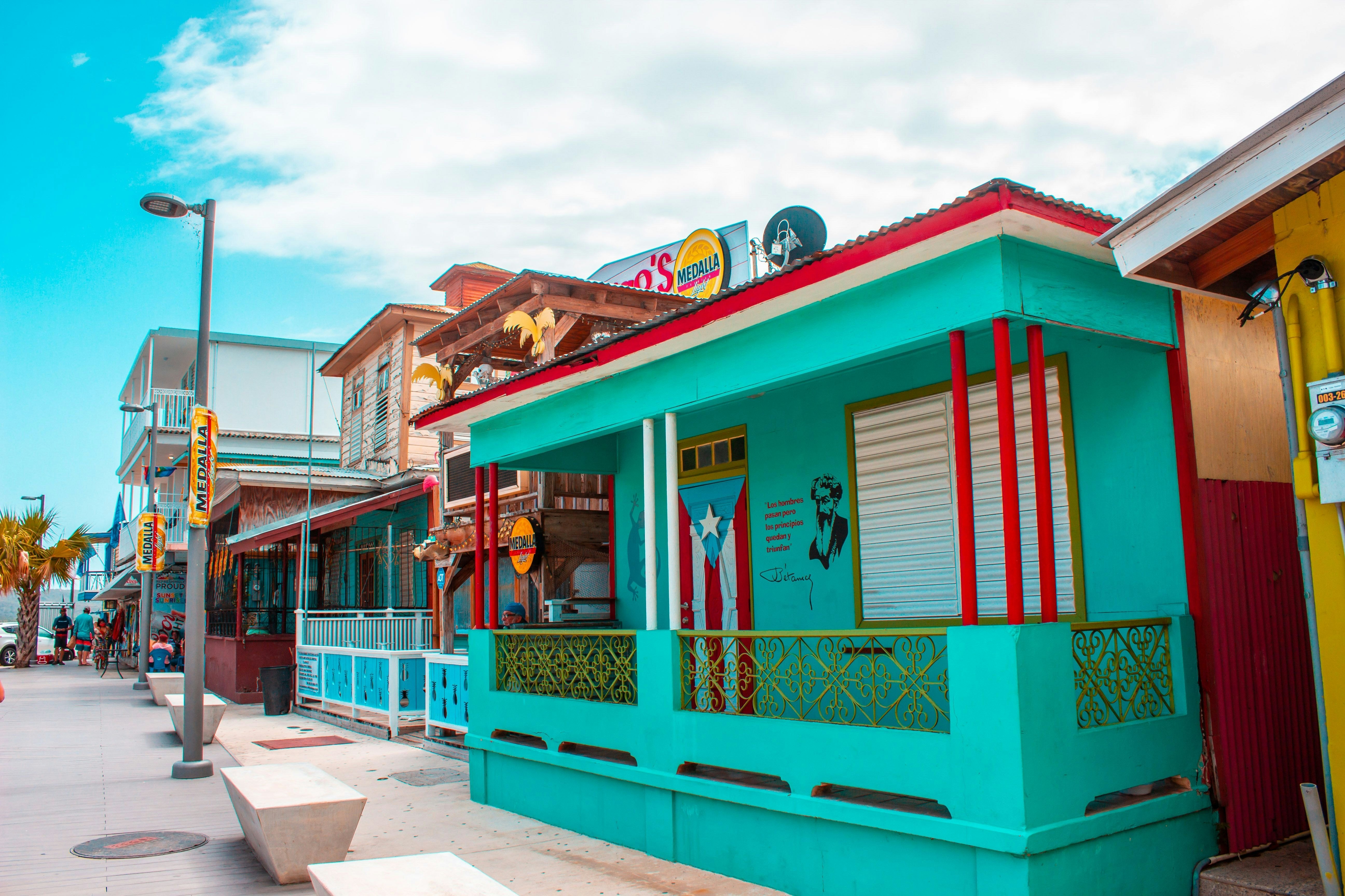 Colorful shops and houses under clear blue sky in Puerto Rico.