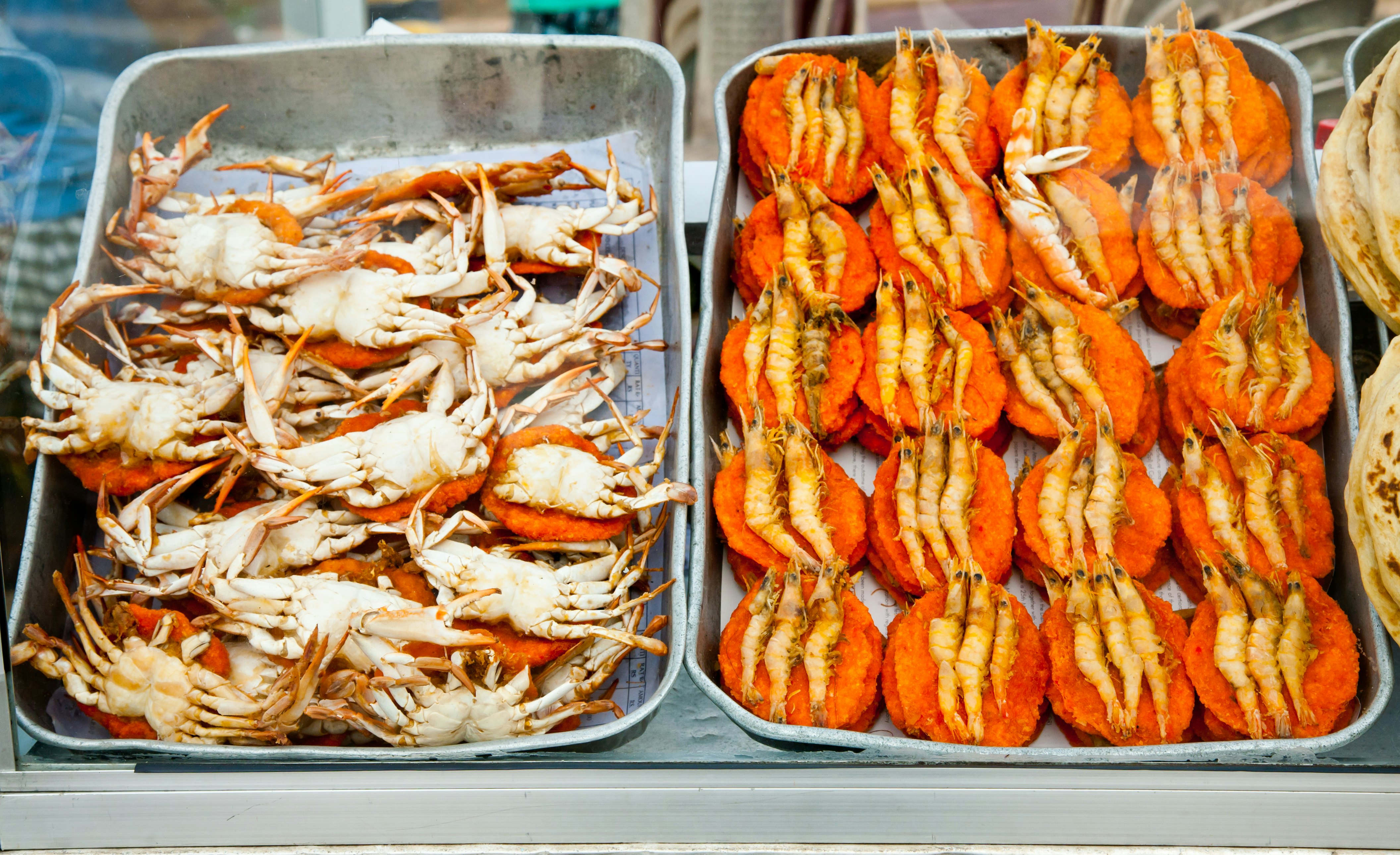 Spicy flat cakes with crabs and prawns on dishes in Colombo