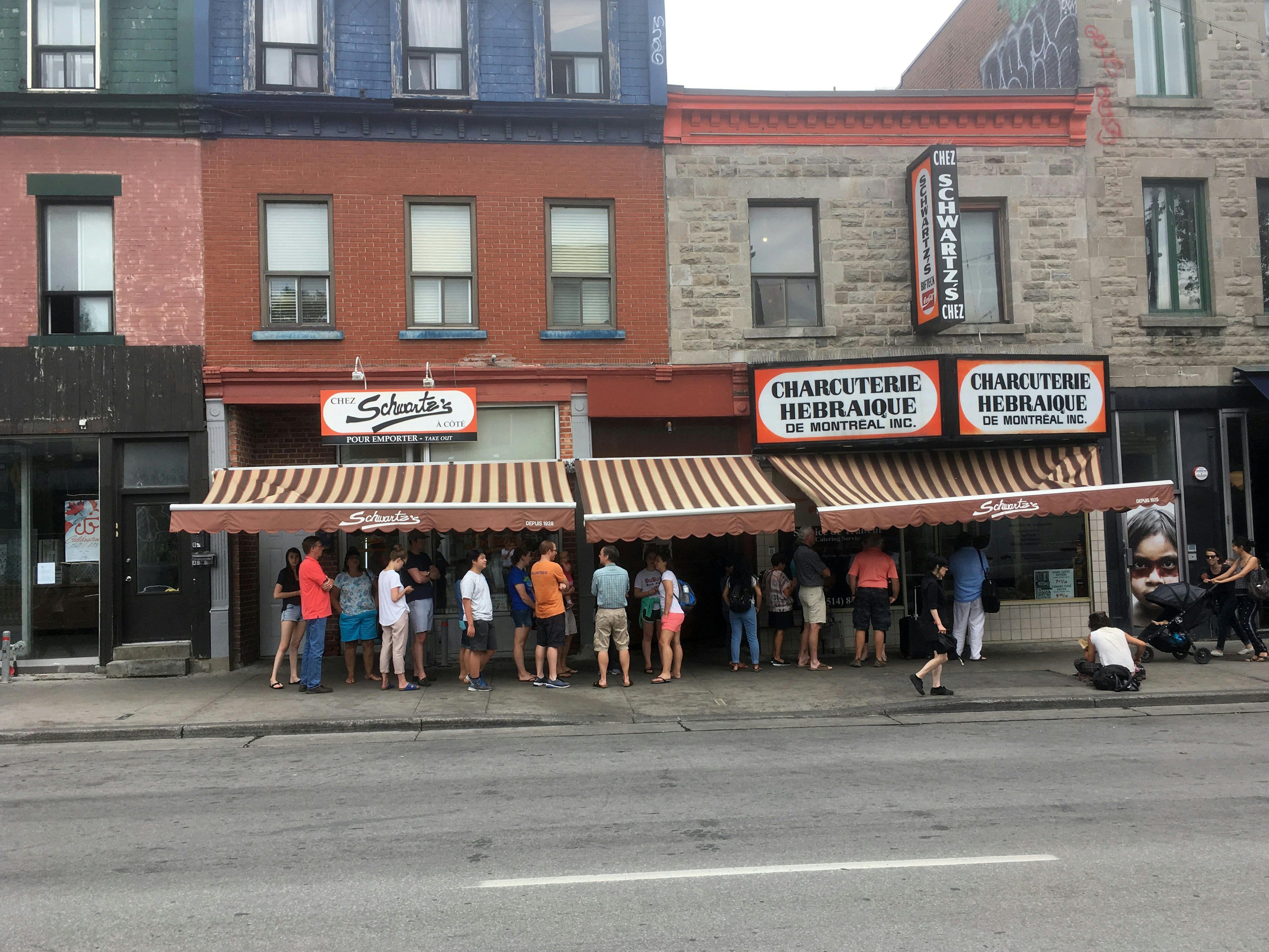 People queueing at lunchtime at Schwartz's Delicatessen, one of Montreal's oldest Jewish delis, claiming to serve the best smoke meats in Montreal since 1928.