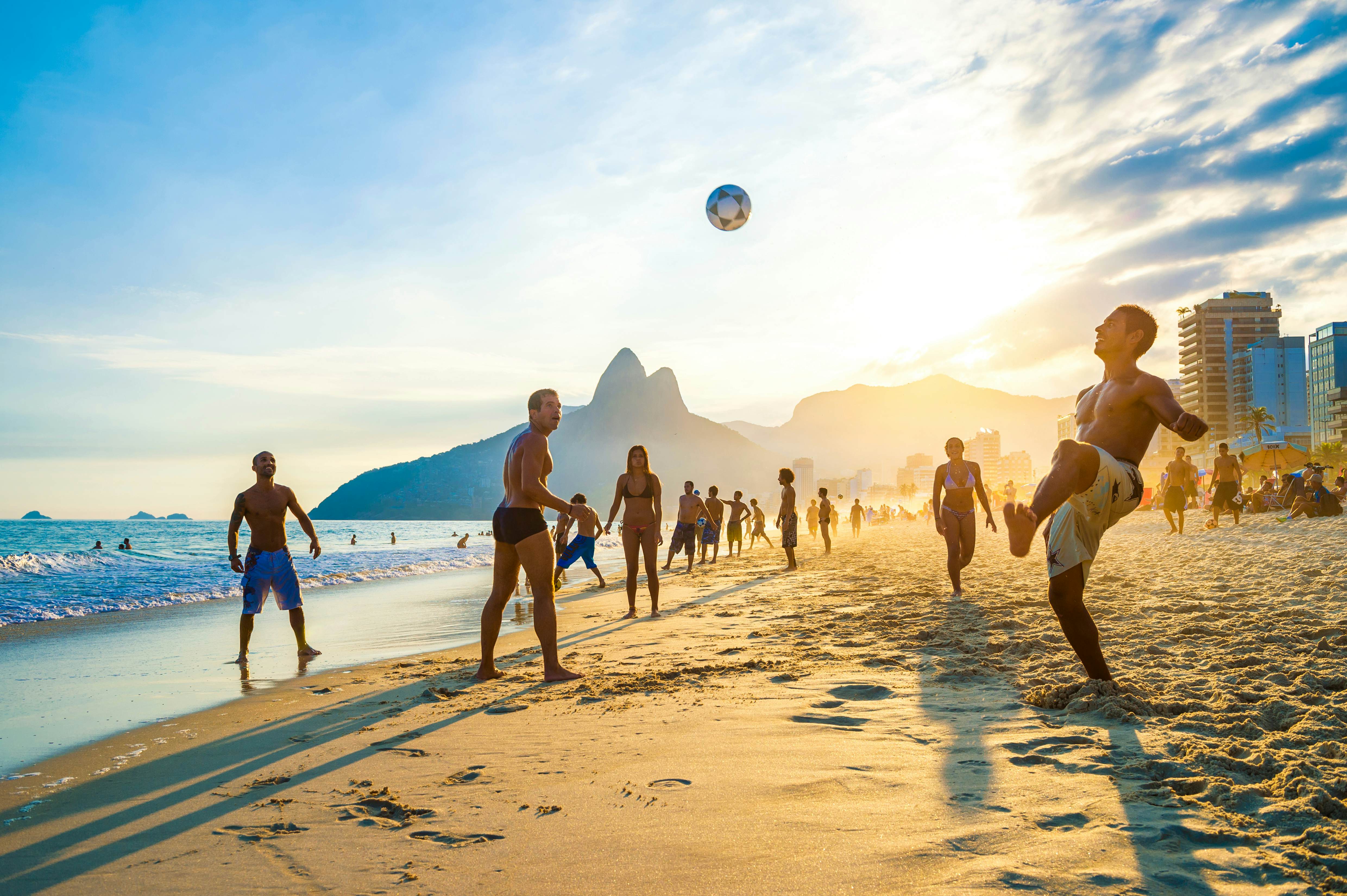 RIO DE JANEIRO - APRIL 01, 2014: Groups of young Brazilians play keepy uppy beach football, or altinho, at sunset on the shore of Ipanema Beach at Posto 9., License Type: media, Download Time: 2025-05-28T09:45:27.000Z, User: lonelyplanetmedia, Editorial: true, purchase_order: 65050 - Digital Destinations and Articles, job: Global Publishing WIP, client: Global Publishing WIP, other: Peterson Haggarty // SS Comp Ingestion