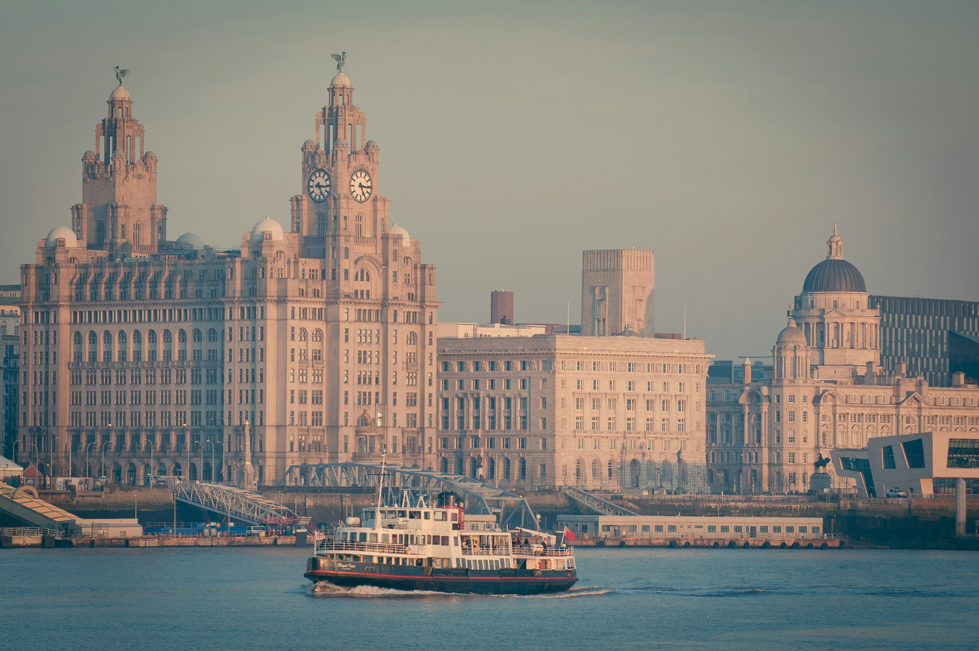 Famous Mersey Ferry in front of the Royal Liver Building, Liverpool, England.