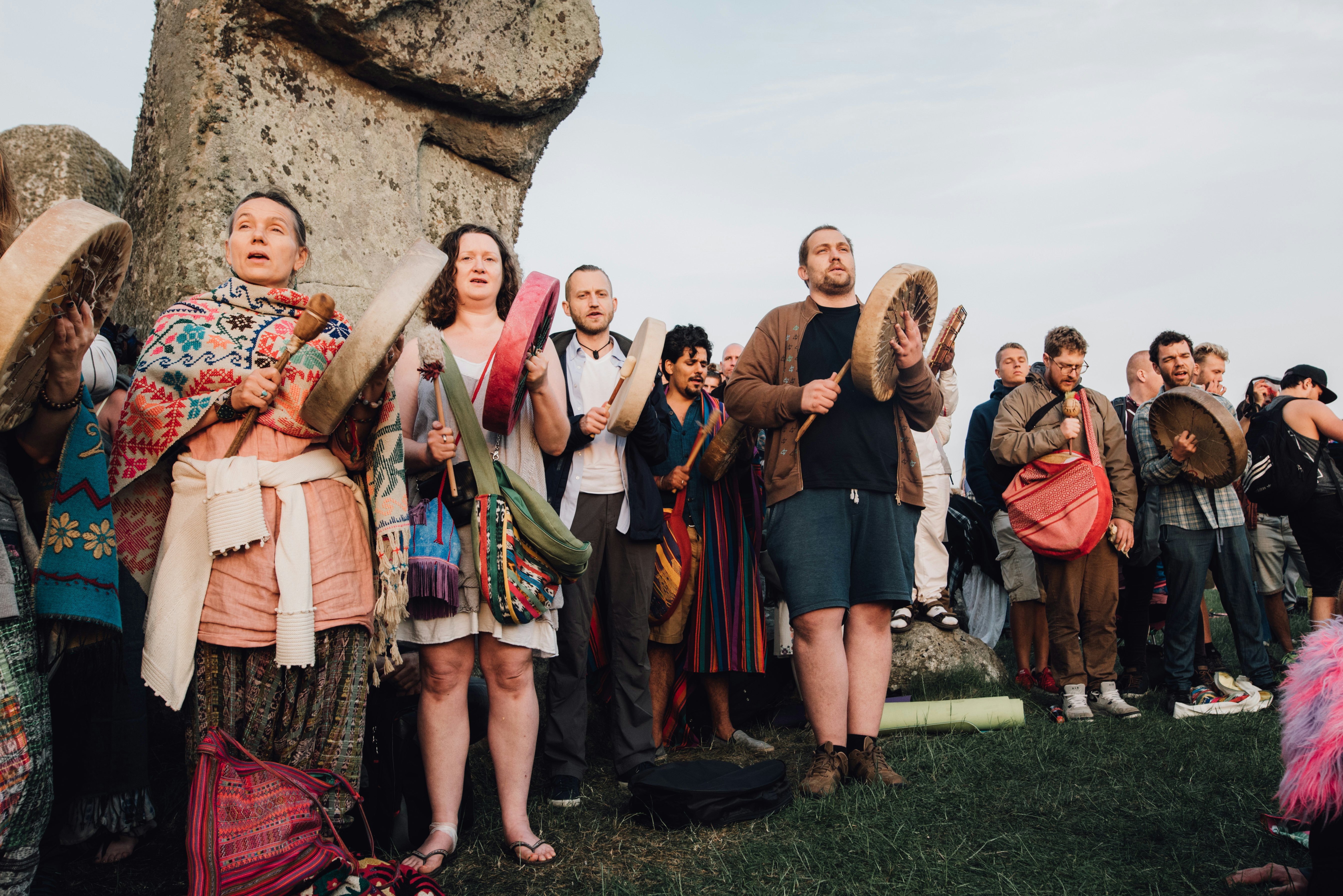 People with drums join the Summer Solstice celebration at Stonehenge in Wiltshire, England.