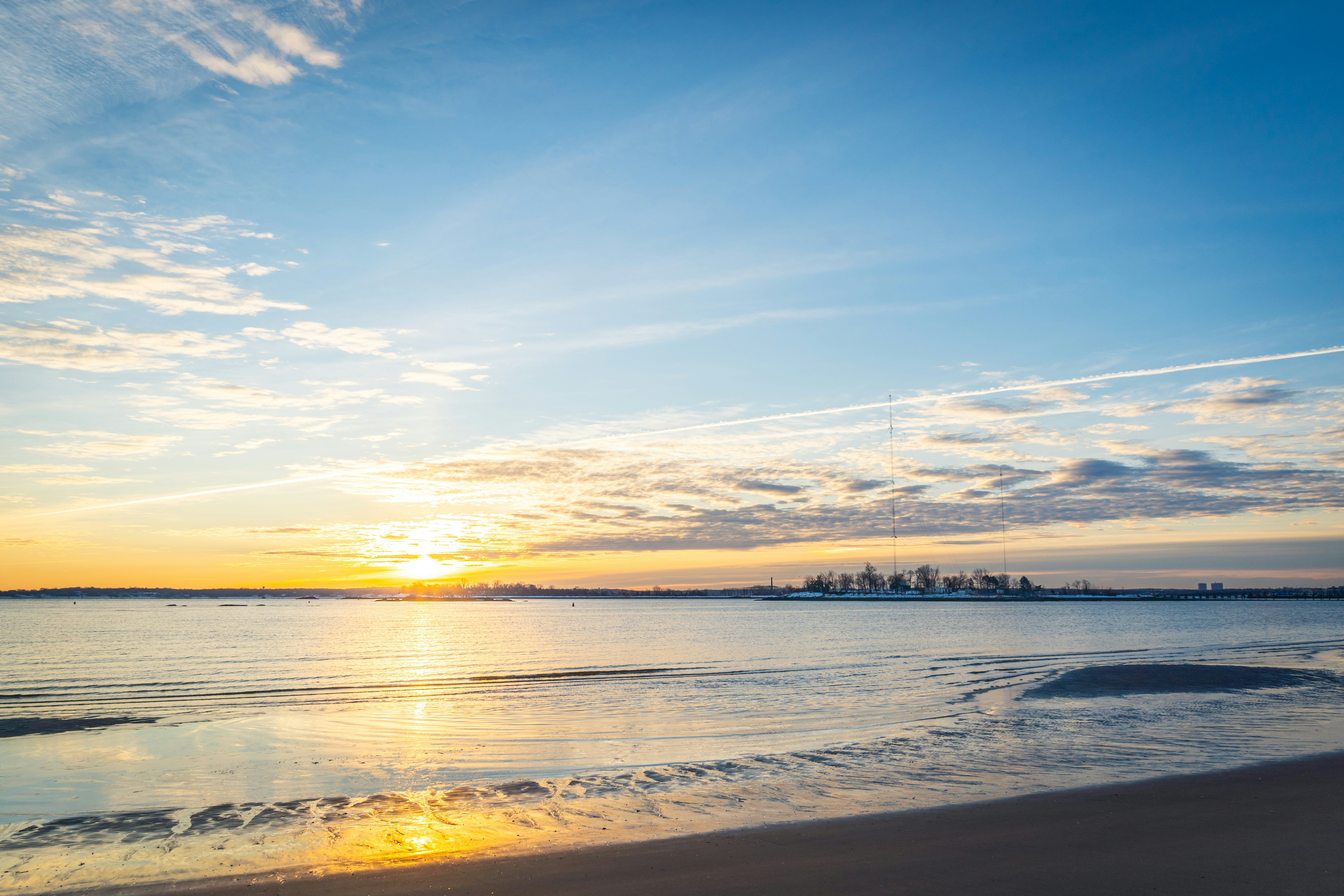 The sun casts an orange glow over the ocean as it rises on a winter's morning.