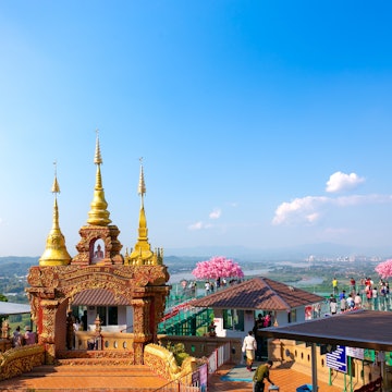 Chiang Rai, Thailand - November 3, 2022: Visitors walk on sky walk at Wat Phra That Pha Ngao in Chiang Saen district, Golden Triangle of Thailand, Myanmar and Laos., License Type: media, Download Time: 2025-05-28T10:04:23.000Z, User: lonelyplanetmedia, Editorial: true, purchase_order: 65050 - Digital Destinations and Articles, job: Global Publishing WIP, client: Global Publishing WIP, other: Peterson Haggarty // SS Comp Ingestion