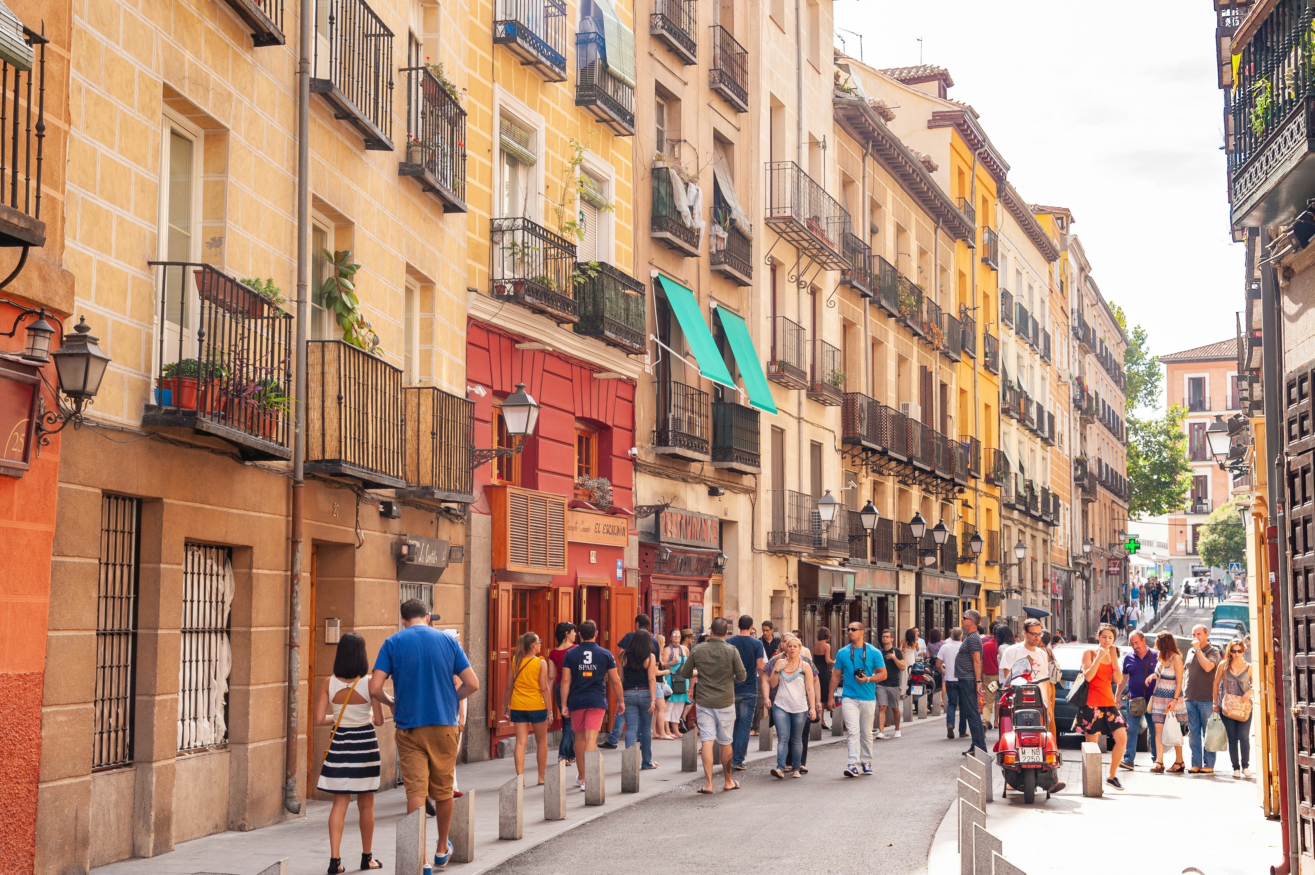 People walking down the popular city centre street Calle Cava Baja in La Latina, Madrid.