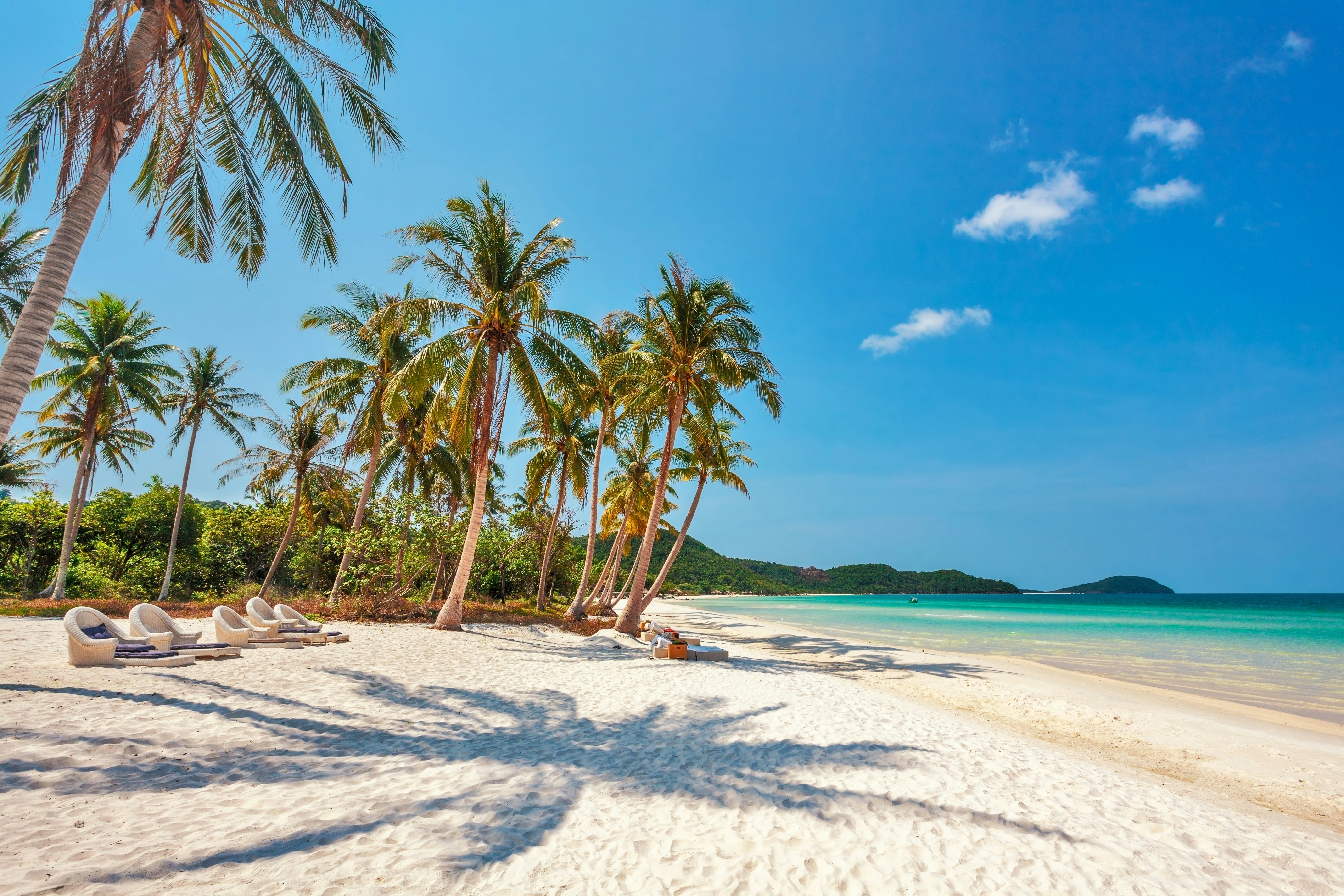 Tropical beach with blue waters under a clear sky at Phu Quoc island in Vietnam.
