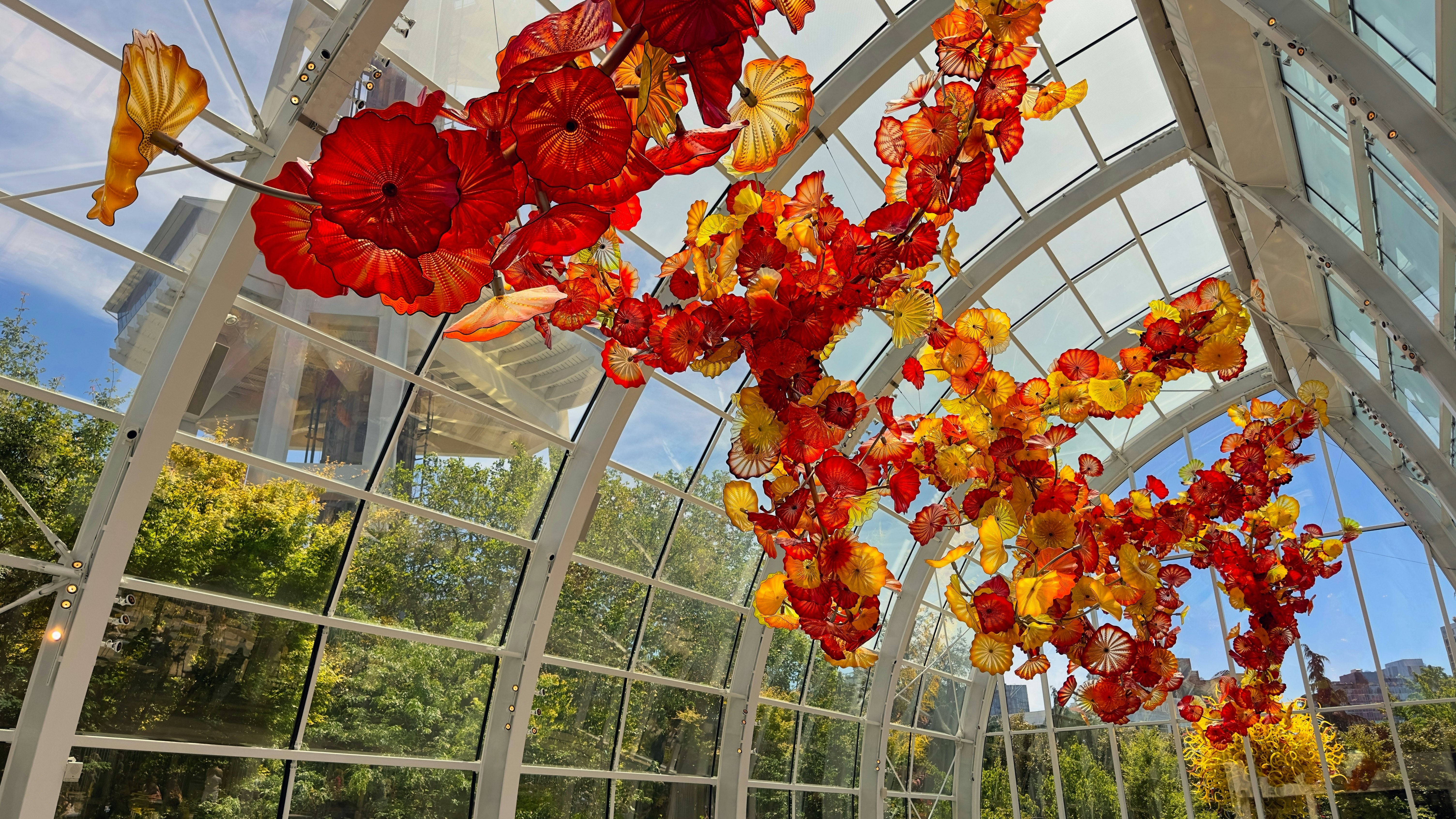 Tangled strings of blown glass flowers hang from the top of the Glasshouse at Chihuly Gardens and Glass in the city's Seattle Center district.