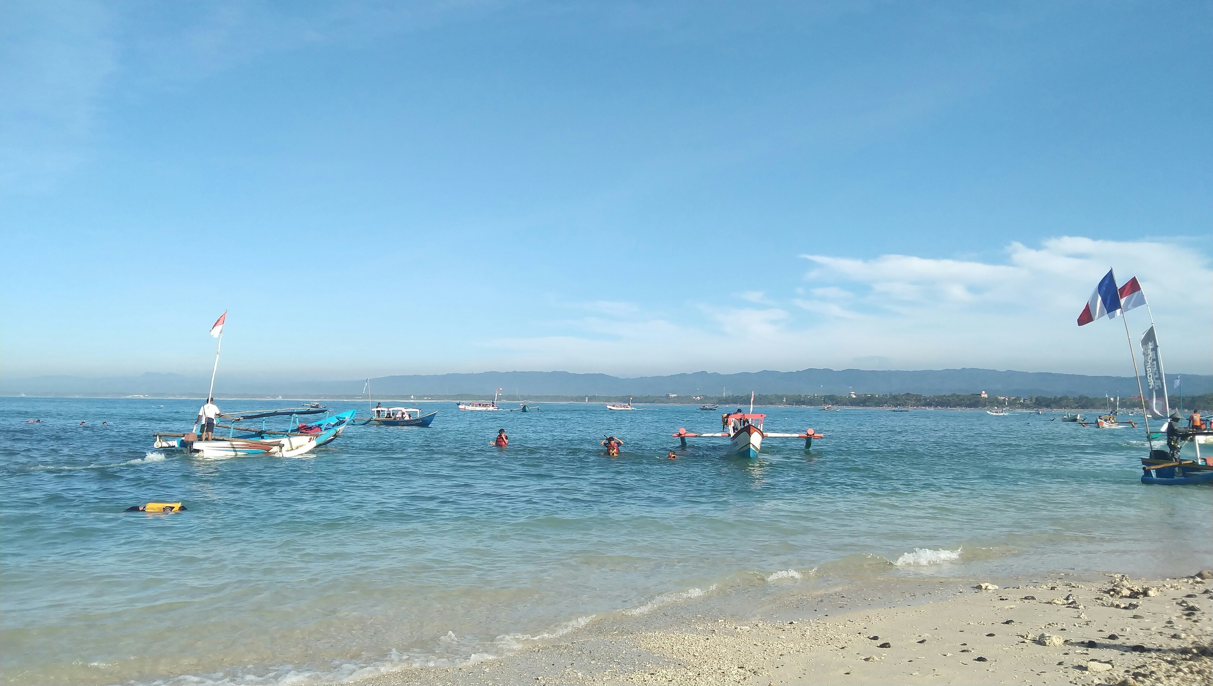 A fishing boat carrying tourists anchored at Pasir Putih beach.