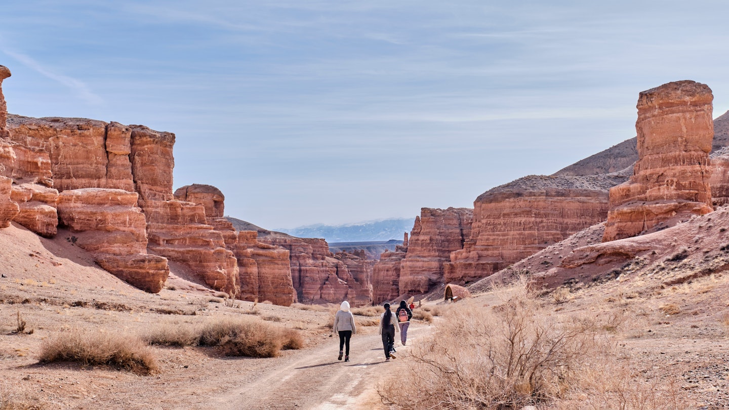 Almaty, Kazakhstan - March 19, 2024: National Nature Park Charyn Canyon in springtime. Valley of Castles. Natural monument, tourist landmark. People walking along road ., License Type: media, Download Time: 2025-07-04T09:50:19.000Z, User: clairenaylor, Editorial: true, purchase_order: 65050 - Digital Destinations and Articles, job: Online ed, client: Kazakhstan best things, other: Claire Naylor