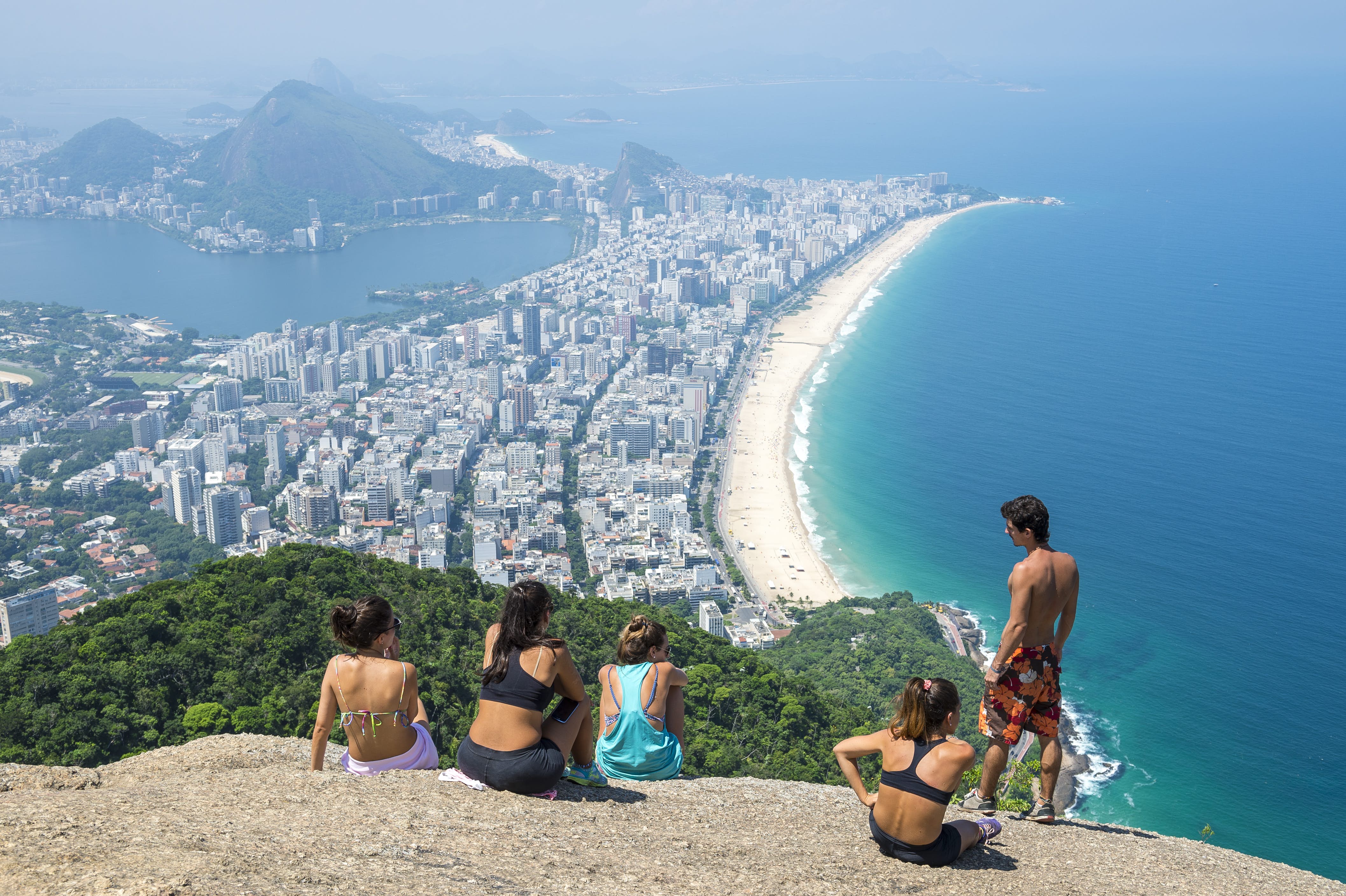 RIO DE JANEIRO - MARCH 9, 2016: Visitors take in the view of the city skyline after a hike to the top of Dois Irmaos (Two Brothers) Mountain, overlooking Ipanema Beach. , License Type: media, Download Time: 2025-05-22T13:23:19.000Z, User: lonelyplanetmedia, Editorial: true, purchase_order: 65050 - Digital Destinations and Articles, job: Global Publishing WIP, client: Global Publishing WIP, other: Pia Peterson Haggarty // SS Comp Ingestion