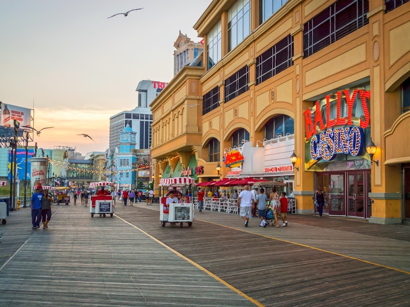 People strolling the Atlantic City Boardwalk at sunset