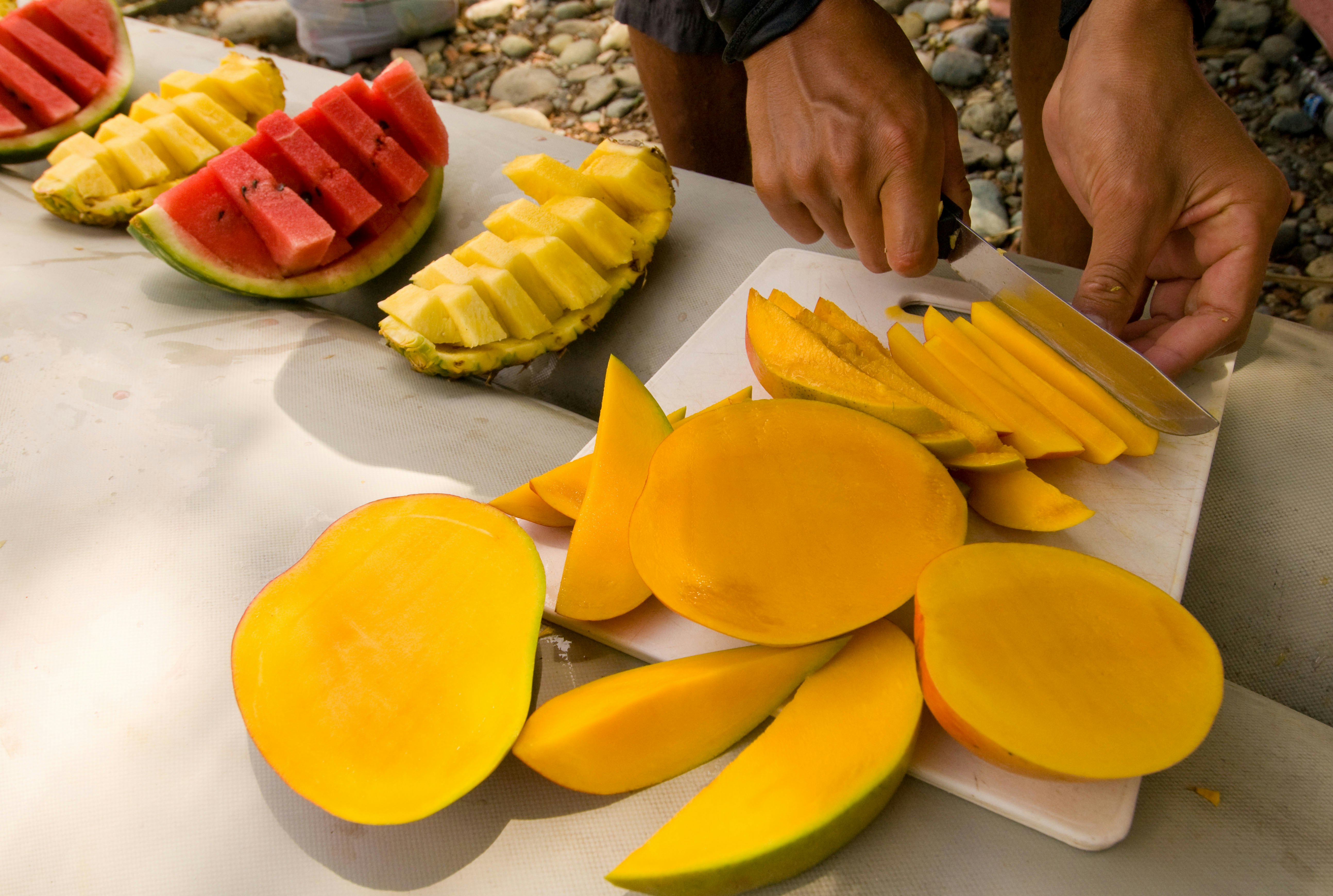 Fresh fruit being cut.