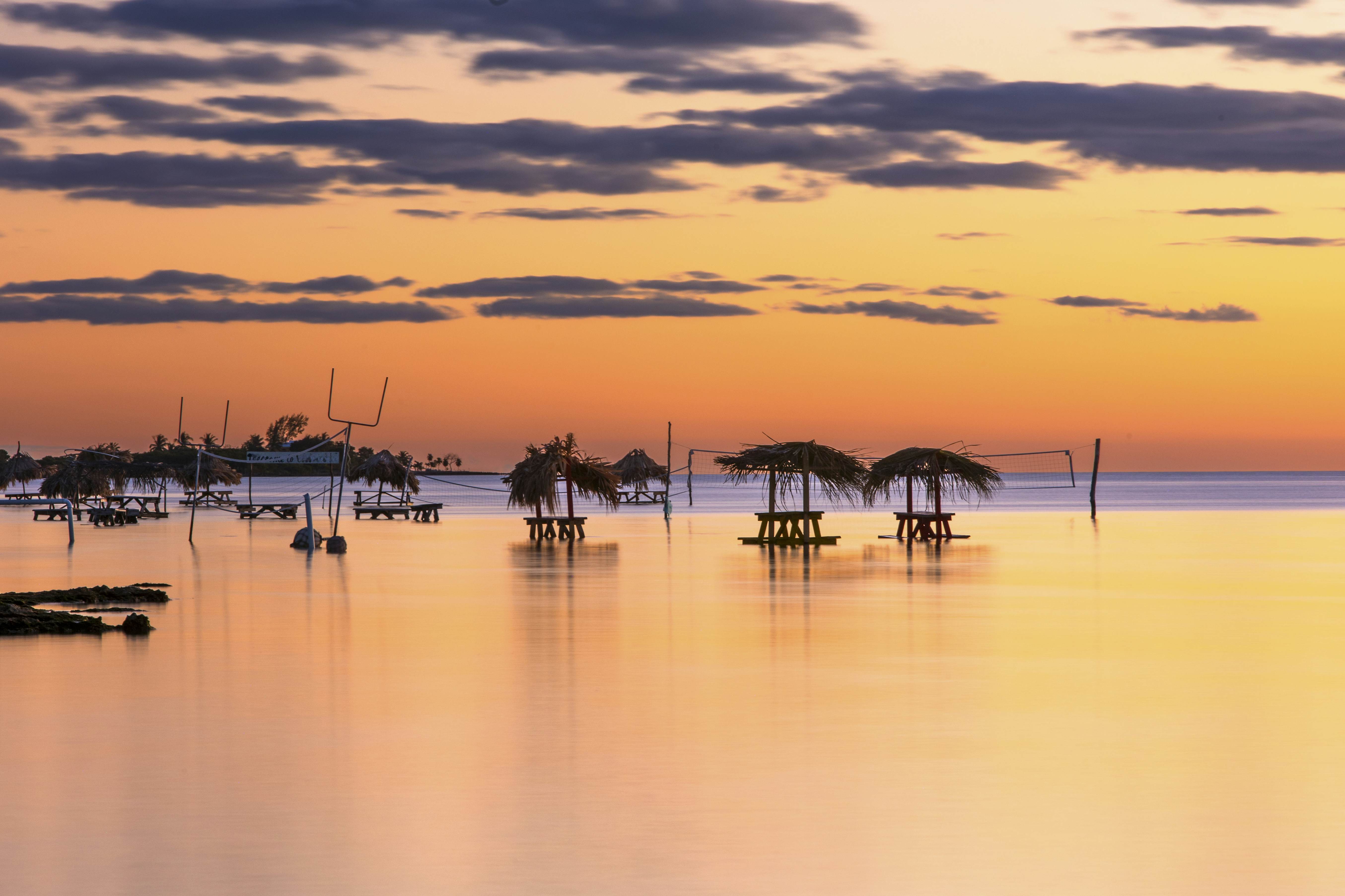 February 2024, Ambergris Caye, Secret Beach, Belize - Aerial views over the Secret Beach area of Ambergris Caye. Bars and restaurants line the shores and bring locals and visitors to visit the beach. Bars and restaurants line the shores of Secret Beach. Tables sit in the water so you can eat and drink partially submerged in tropical water. The area of Secret Beach is rapidly being developed.
2108597796
bar, bar and restaurant, party, silhouette, tropical beach, tropical island, tropical water, turquoise water, warm water, party spot, party destination