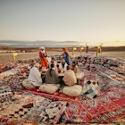 Wide shot of Moroccan waiters dressed in traditional attire serving friends and family tajine during sunset outdoor dining desert experience at luxury Agafay desert camp
2189646594
exotic travel