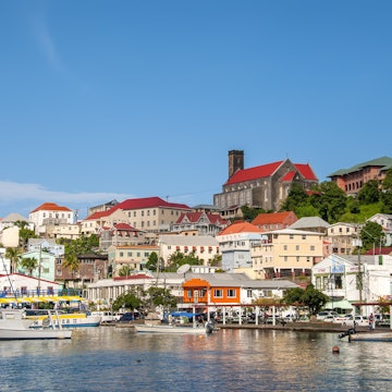 Scenic landscape of the Carenage harbor, boats, and colorful buildings on hillside, St George's, Grenada.
476710901
Carenage Harbour St Georges post Hurricane Ivan, Carenage waterfront promenade and harbor color colour, Grenada Grenadines Southern Caribbean island, sunny blue sky horizontal, open negative space
Scenic landscape of the Carenage harbor, boats, and colorful buildings on hillside, St George's, Grenada.