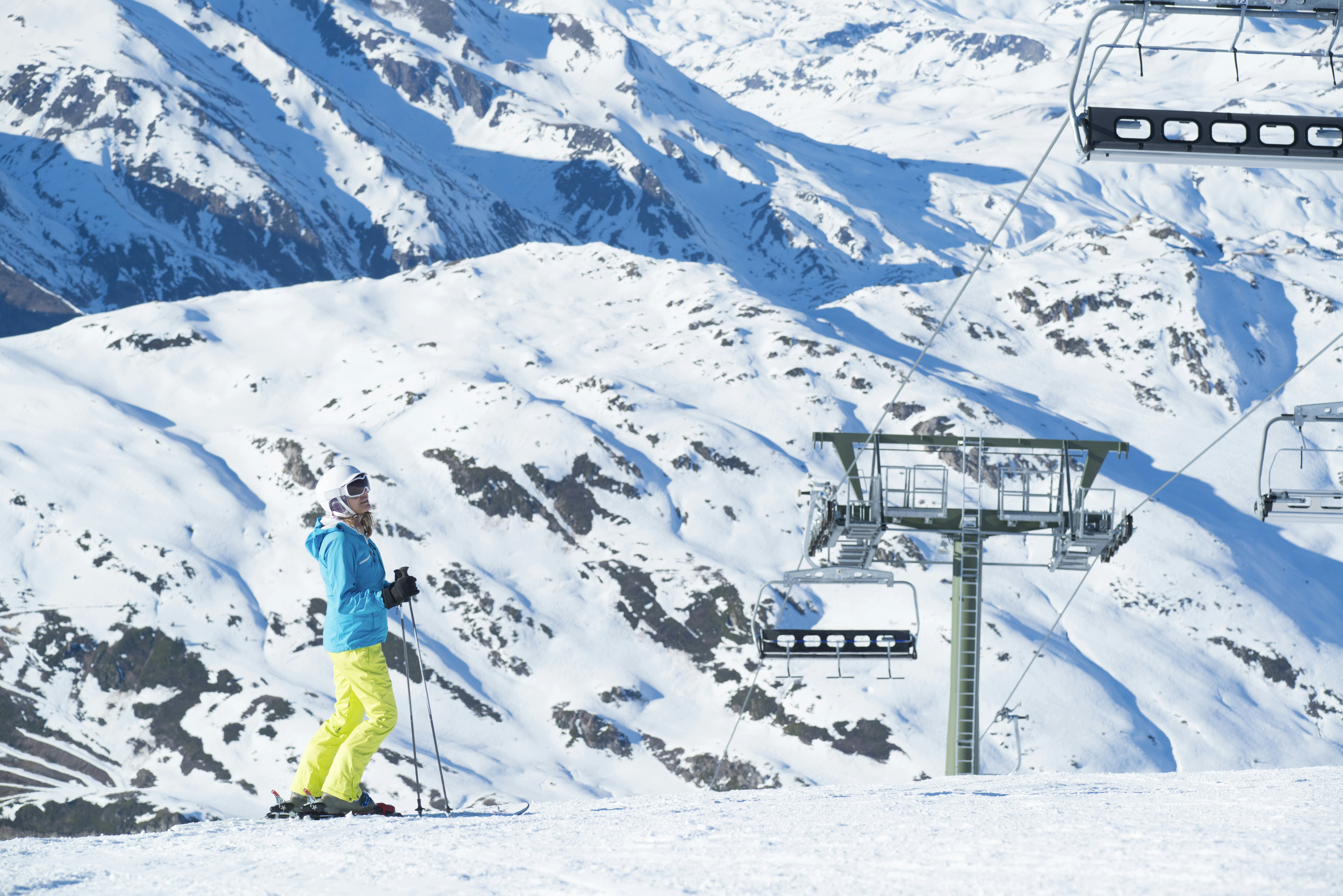 A skier and ski lifts in the Pyrenees, Catalonia, Spain, in winter.