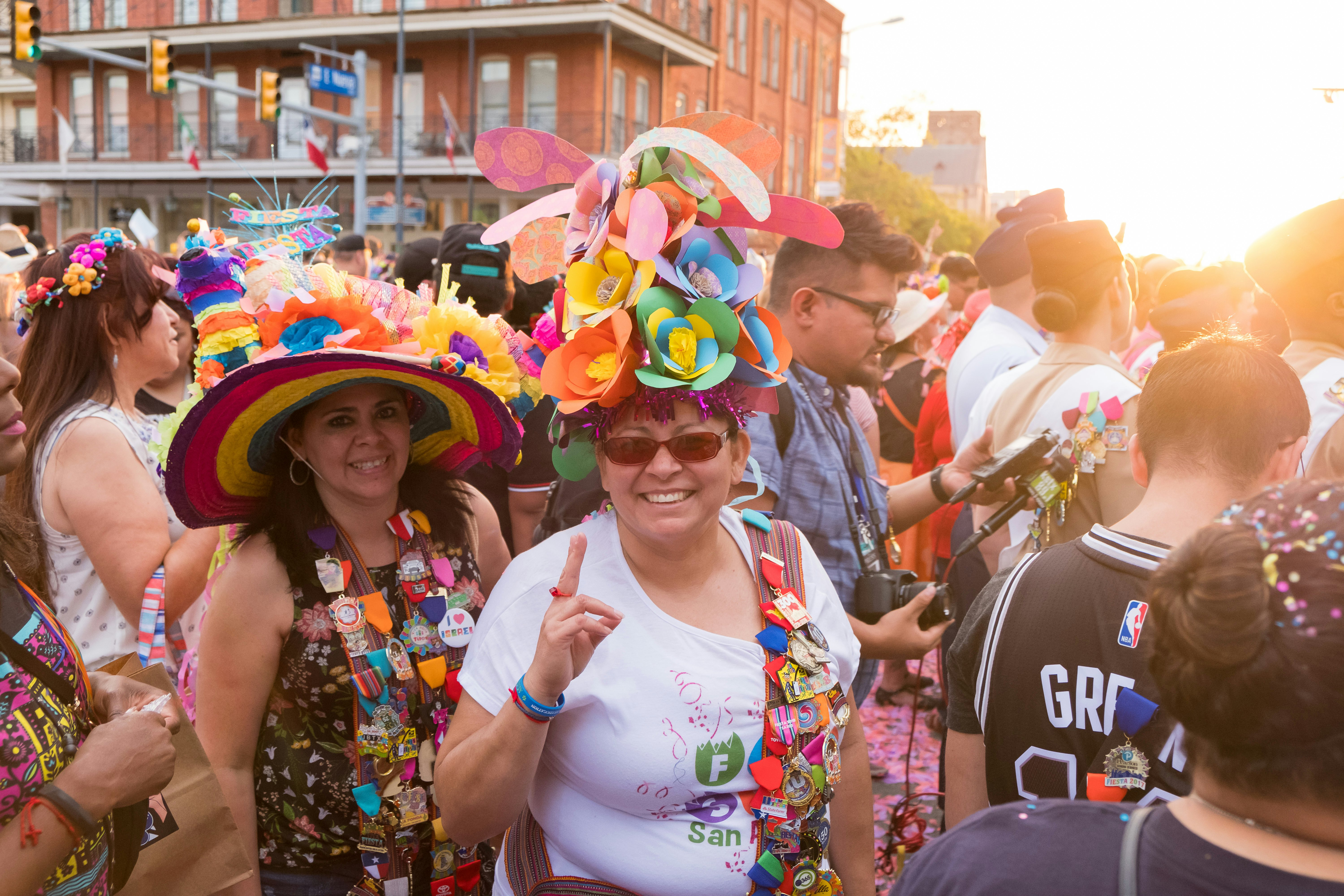 People wearing crazy hats, medals and pins during the opening night of Fiesta San Antonio in Texas.