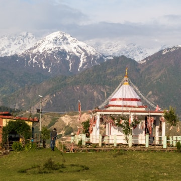 Munsyari, Uttarakhand/India - April 19 2019: The Nanda Devi temple set on a green hillside in the Himalayan town of Munsyari with the Panchachuli range in the background. License Type: media Download Time: 2024-06-24T04:06:28.000Z User: Norma.PrauseBrewer_LonelyPlanet Is Editorial: Yes purchase_order: 56530