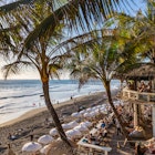 CANGGU, BALI / INDONESIA - NOVEMBER 5, 2019: View on a beautiful beach restaurant terrace La Brisa crowded with tourists at the famous Echo Beach at sunset  License Type: media  Download Time: 2024-03-18T03:20:42.000Z  User: mvm_lonelyplanet  Is Editorial: Yes  purchase_order: