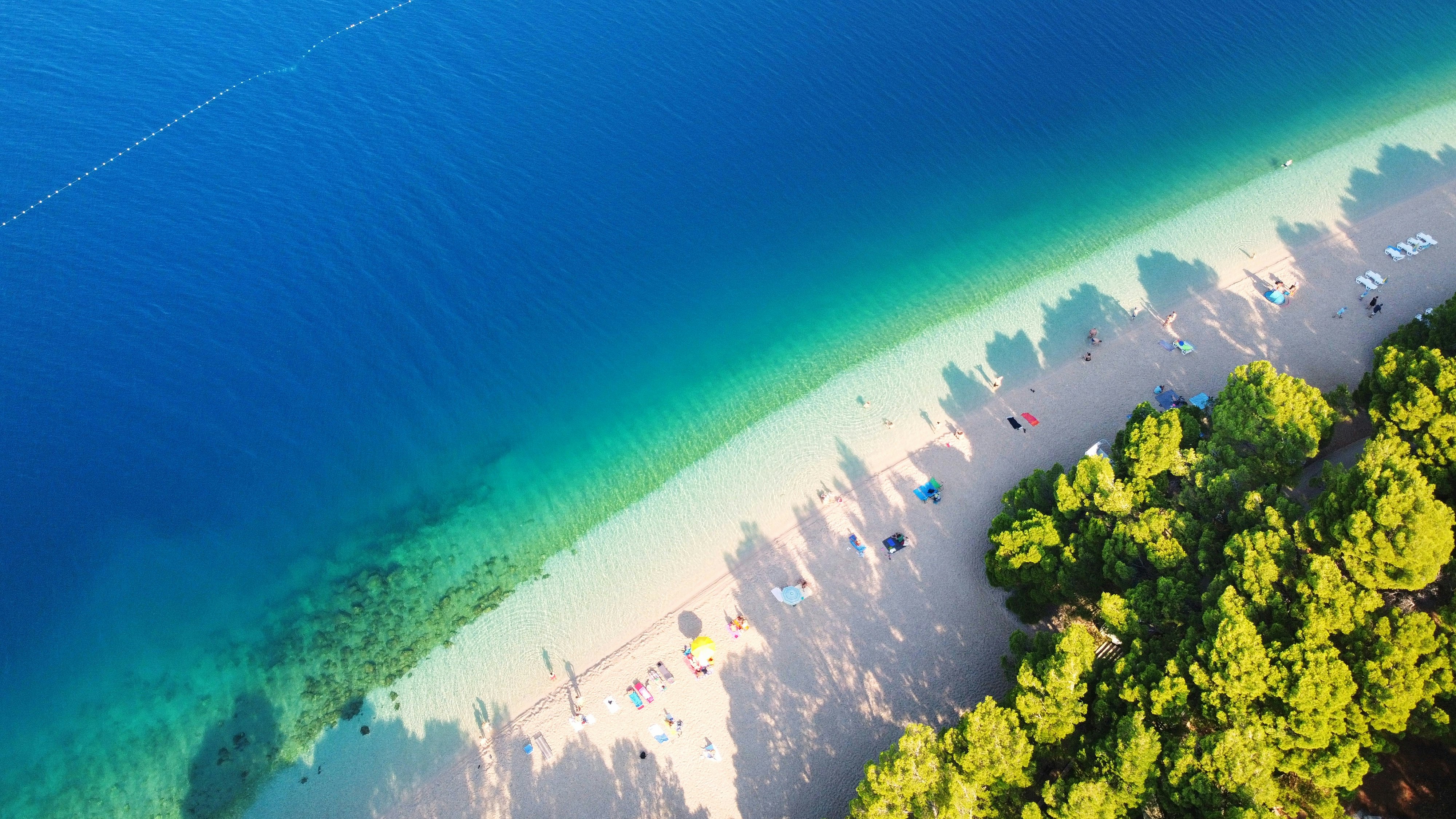 Aerial view of people, sand and sea at Punta Rata beach in Brela, Croatia