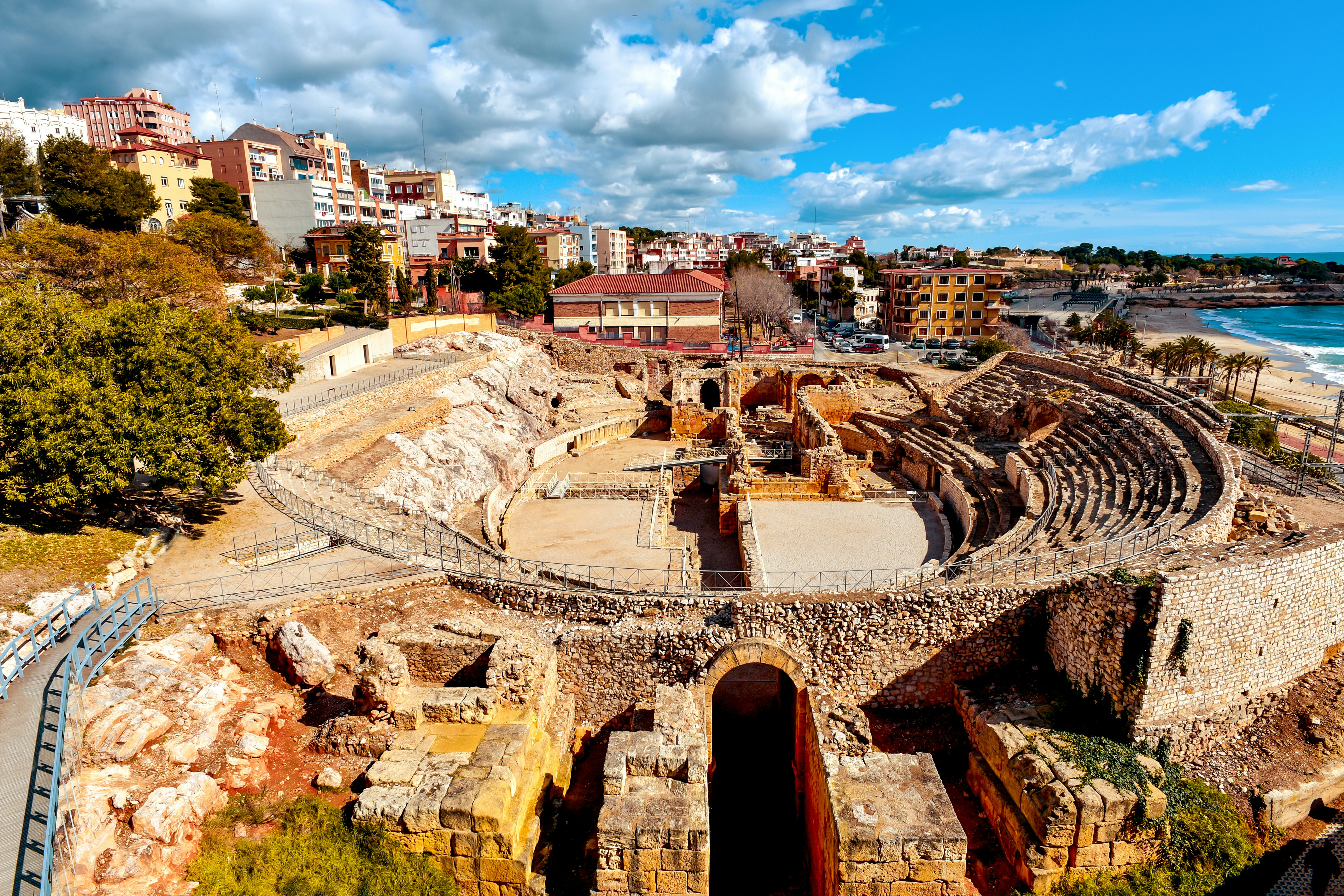 A panoramic view of the ancient Roman amphitheater of Tarragona, Spain, next to the Mediterranean sea