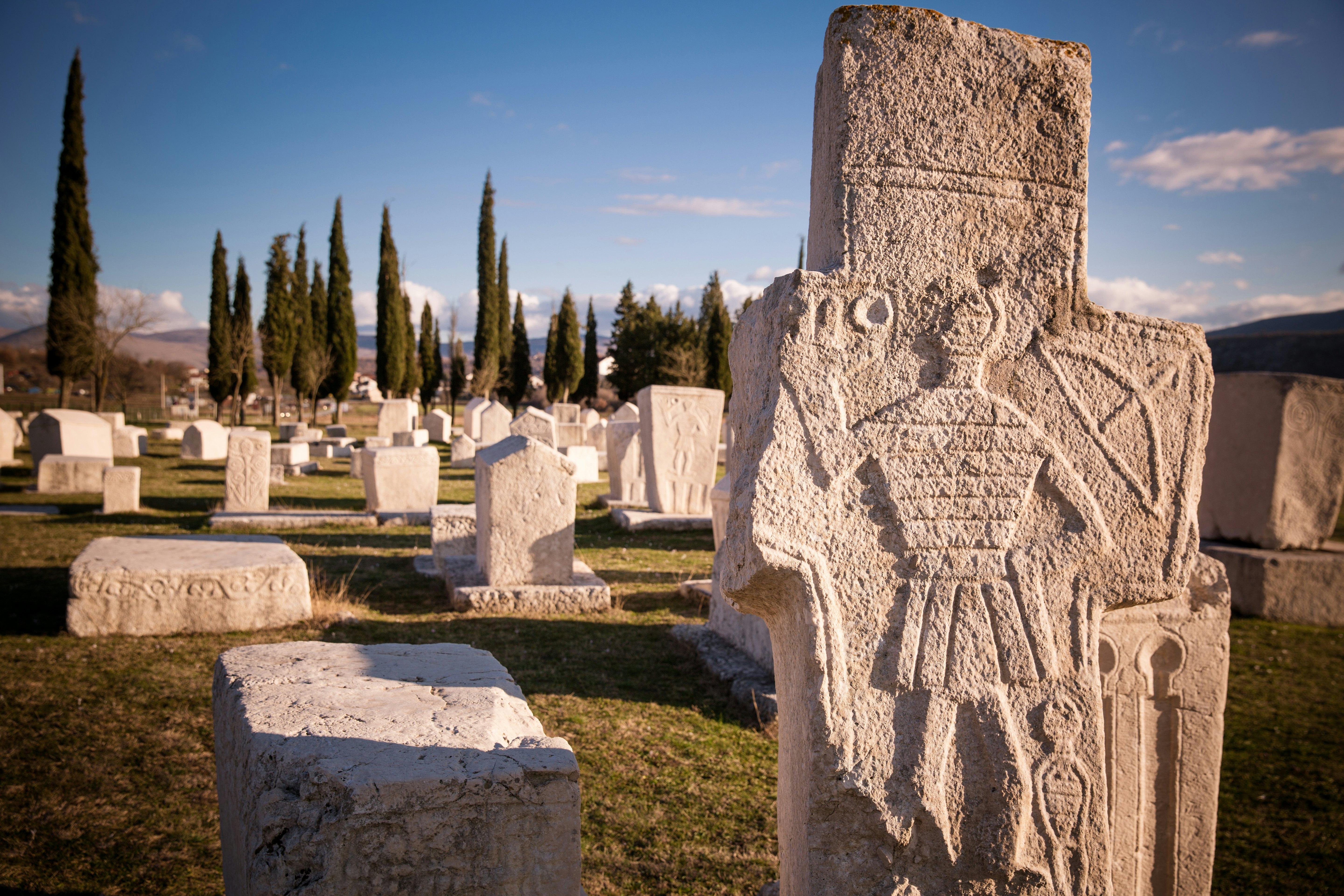 A series of carved ancient gravestones.