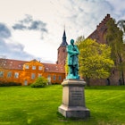Cathedral of Saint Canute and Statue of Hans C Andersen in Odense, Denmark  License Type: media  Download Time: 2023-03-10T17:02:49.000Z  User: dermothegarty77  Is Editorial: No  purchase_order: