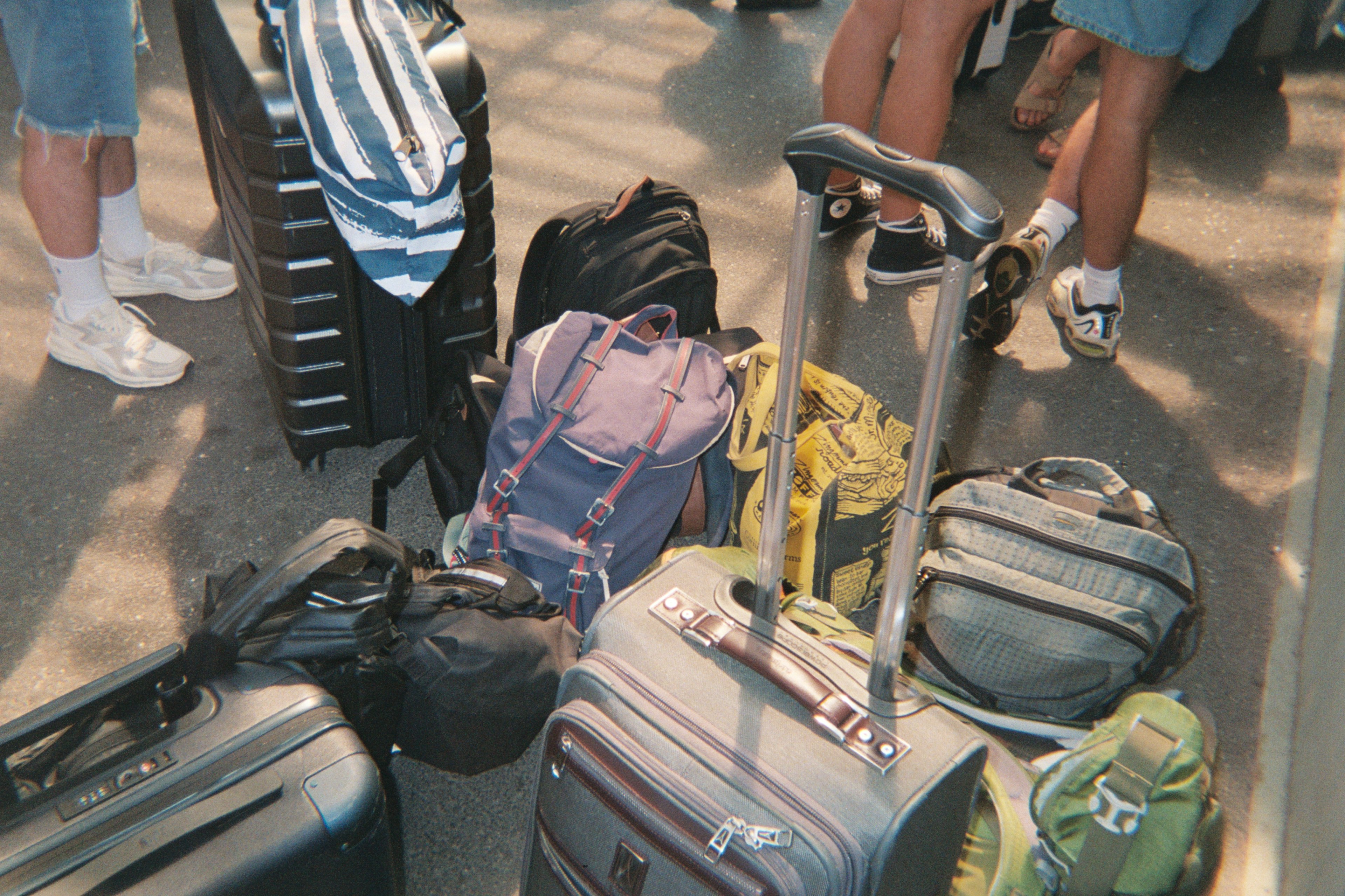 Suitcases and bags grouped together while people wait to board the ferry to Fire Island.