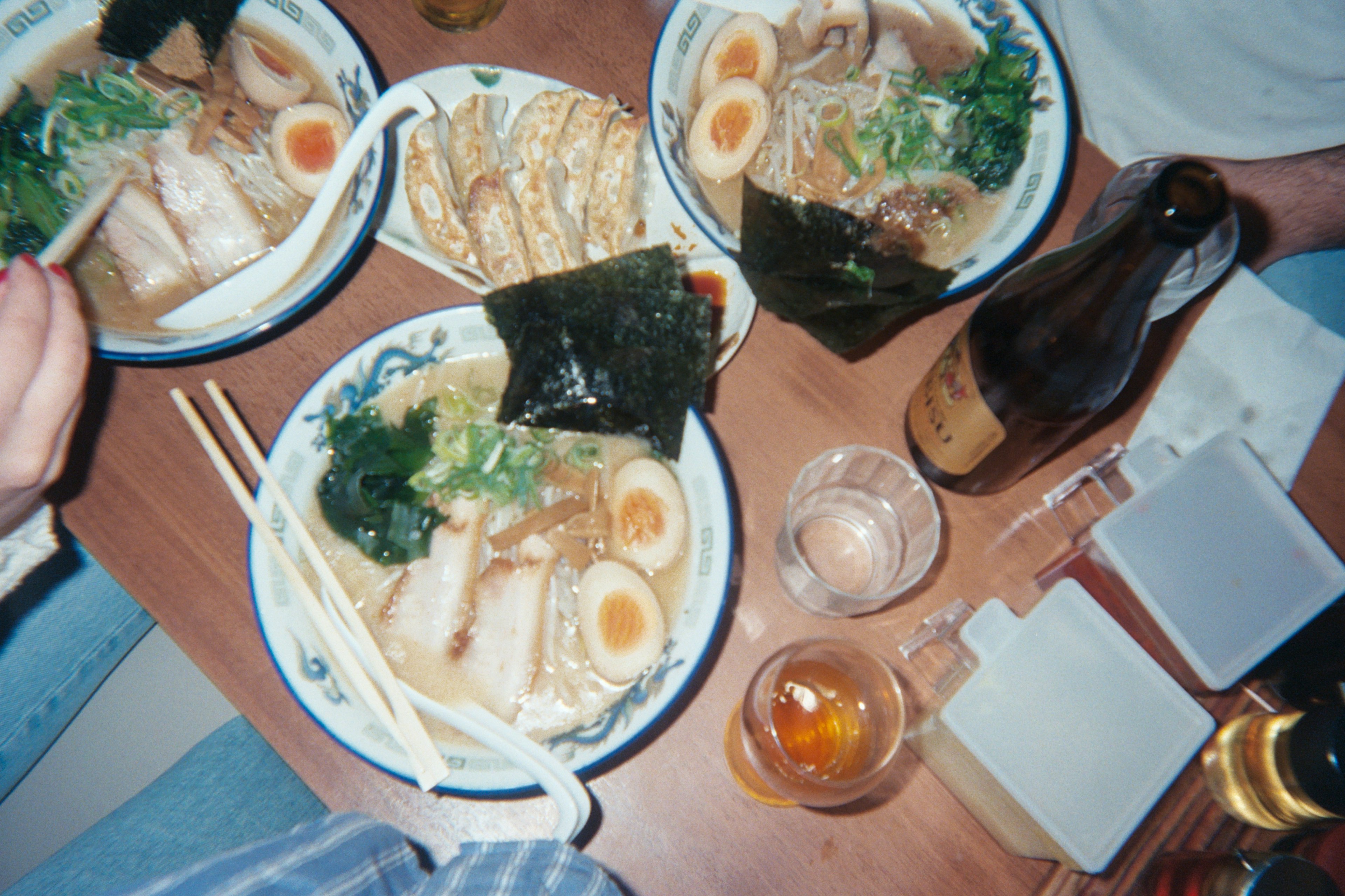 Bowls of ramen and glasses of beer on a table