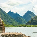 Scenic view of Tautira Tahiti Iti with a monument next to beach, French Polynesia. Exotic mountain landscape., License Type: media, Download Time: 2025-08-28T12:22:45.000Z, User: clairenaylor, Editorial: false, purchase_order: 65050 - Digital Destinations and Articles, job: Online editorial, client: French Polynesia things to know, other: Claire Naylor