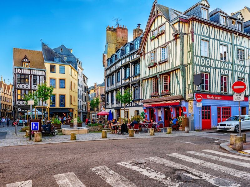 A street with half-timbered buildings, cobbled streets and restaurants with outdoor terraces