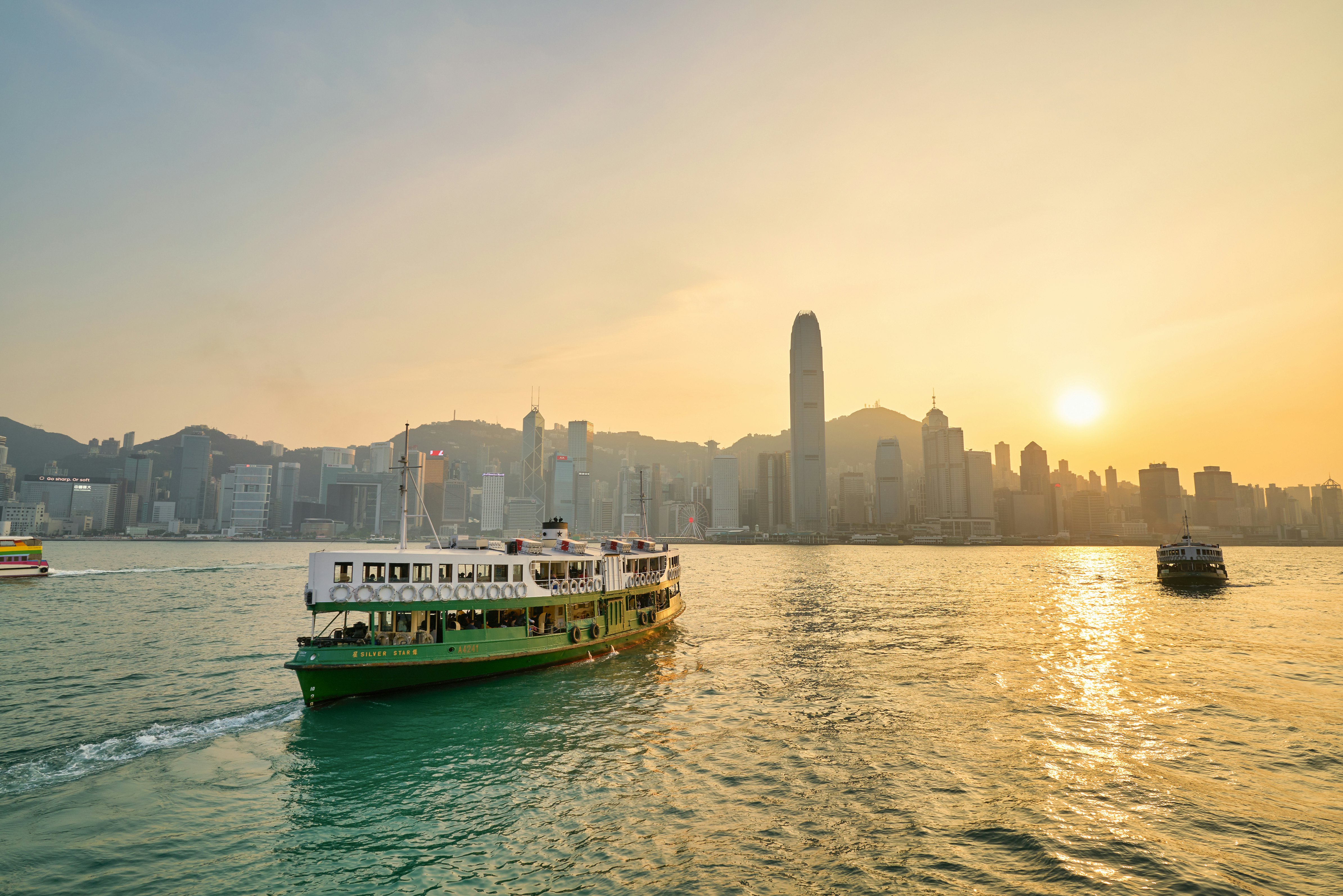 A Star Ferry crossing Victoria Harbour in the late afternoon sun.
