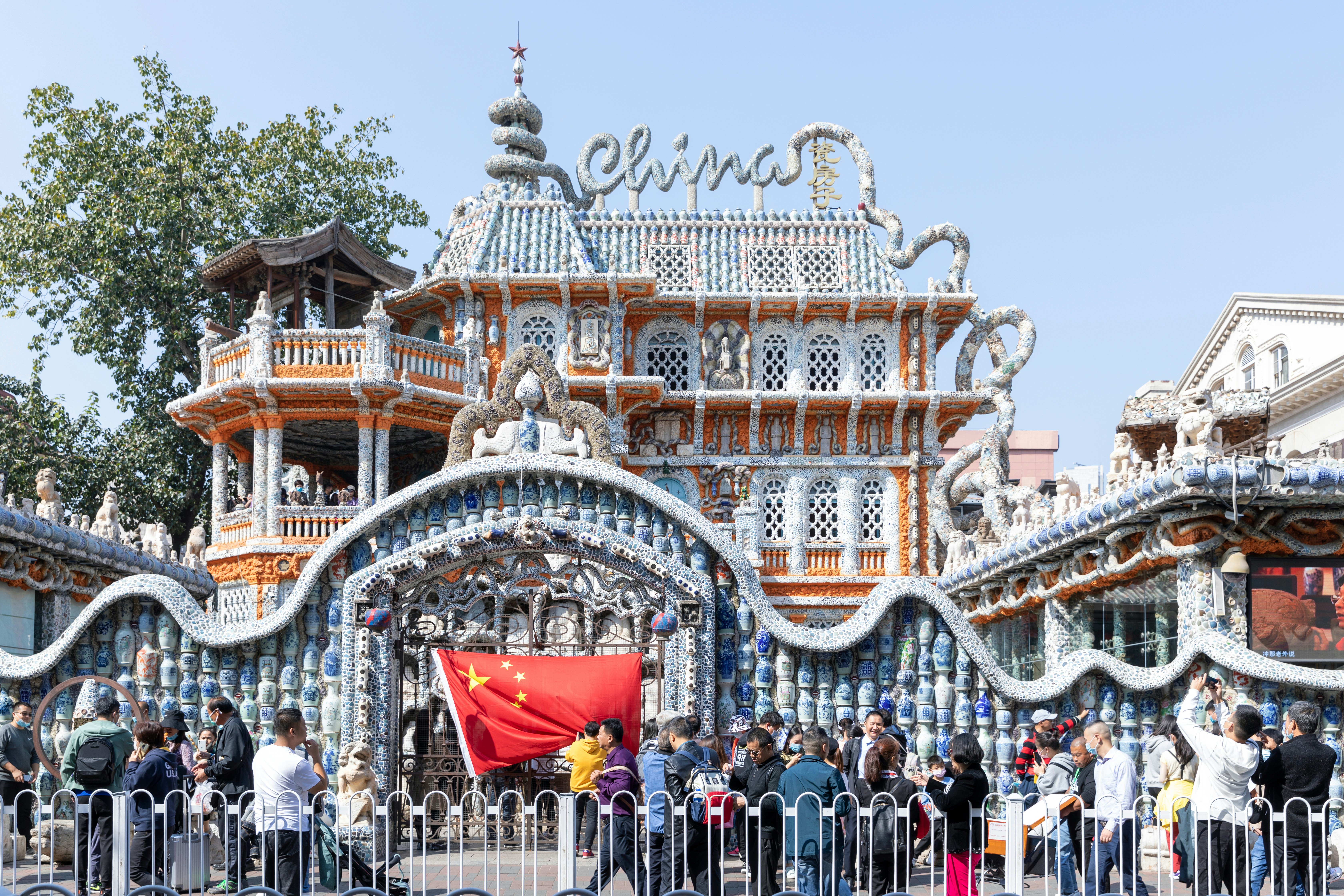 A line of sightseers in front of the Porcelain House in Tianjin China.
