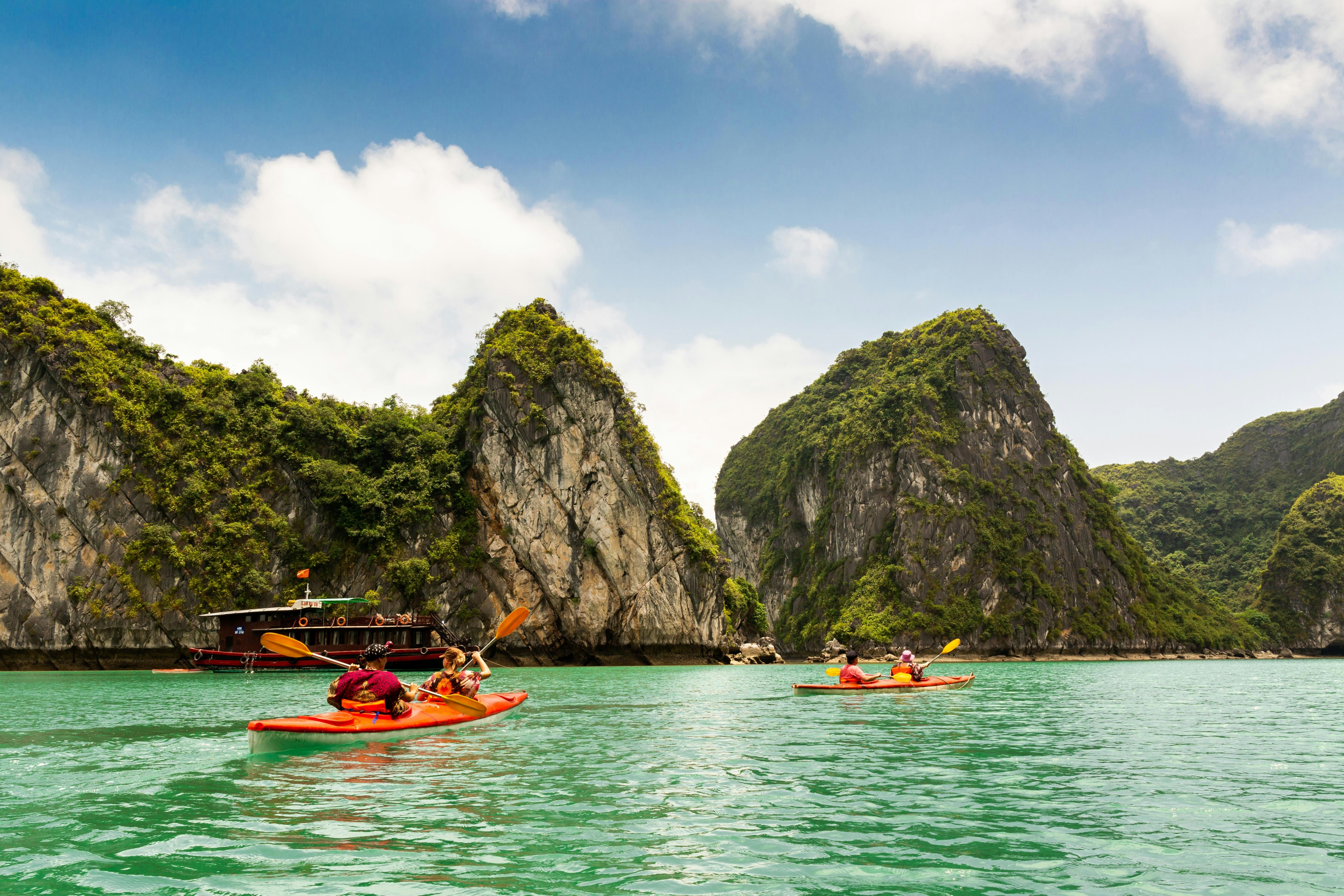 Two kayaks paddling in Halong Bay Vietnam