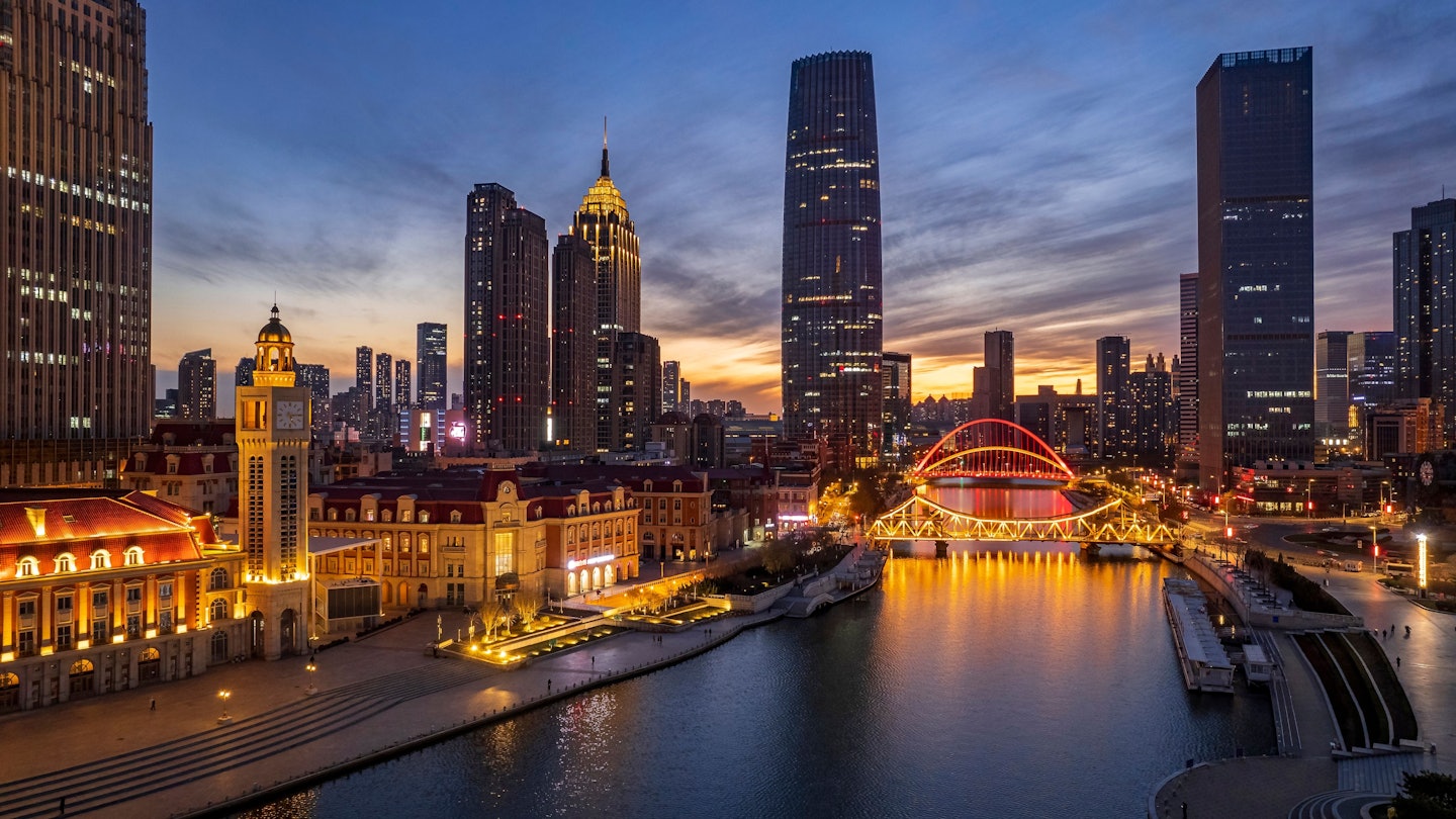 An aerial shot of an urban skyline with landmarks along the Haihe River in Tianjin, China at sunset, License Type: media, Download Time: 2025-08-07T10:05:14.000Z, User: joebindloss38, Editorial: false, purchase_order: 65050 - Digital Destinations and Articles, job: Online Editorial, client: The 9 best things to do in Tianjin, China, other: Joe Bindloss