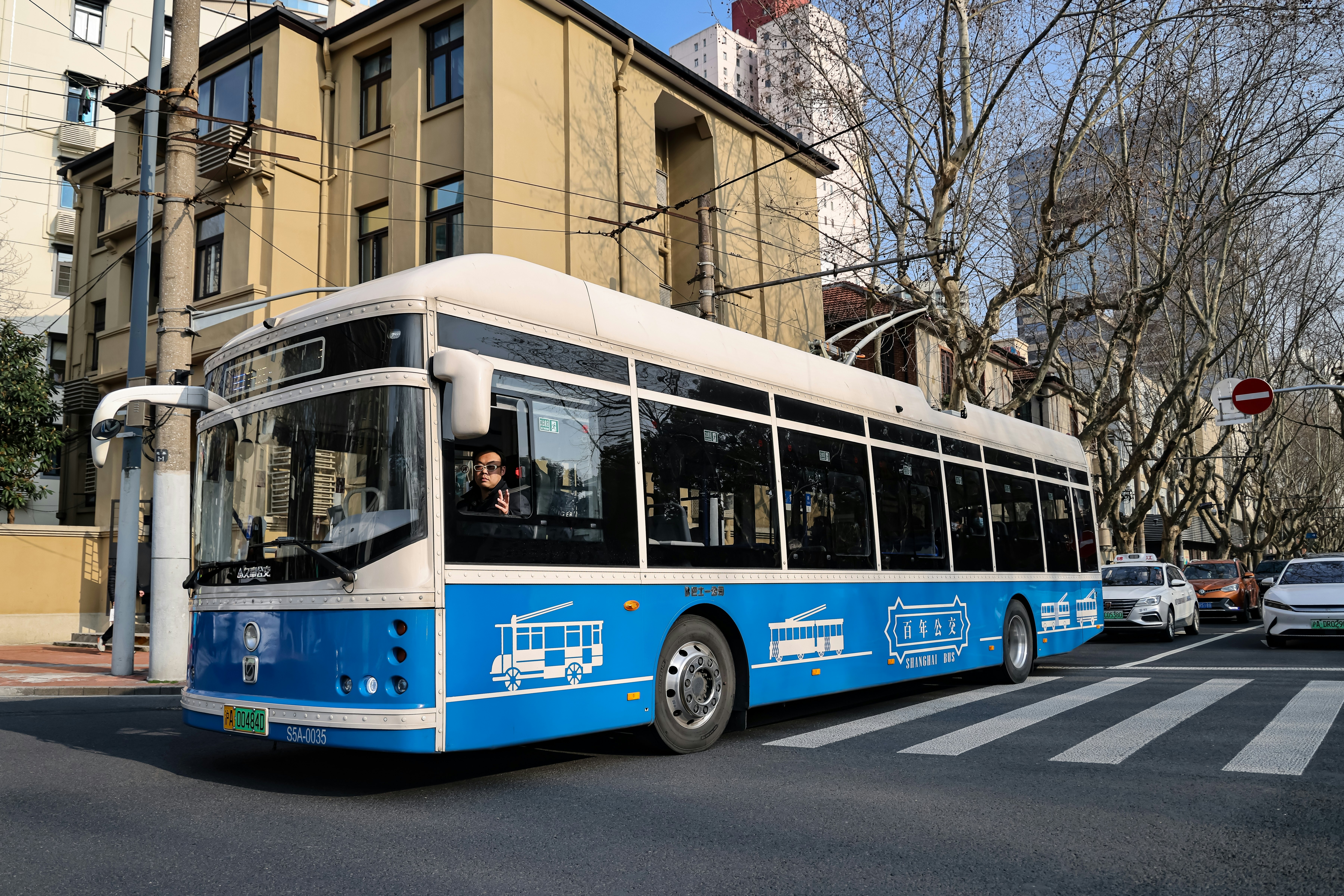 A public bus passes along a road in Shanghai, China.