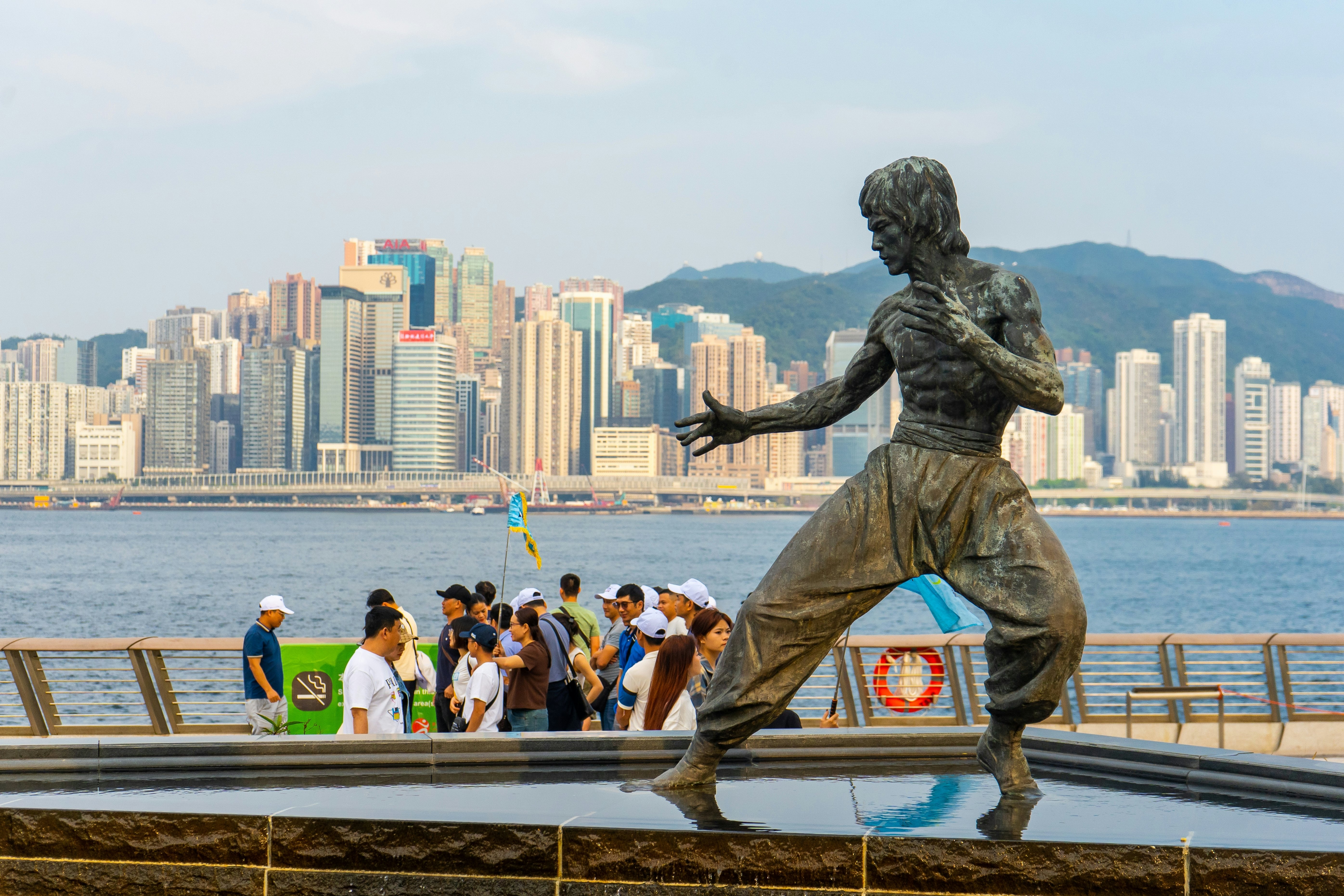 Tourists pass a statue of Bruce Lee on the Avenue of Stars in Kowloon, Hong Kong.