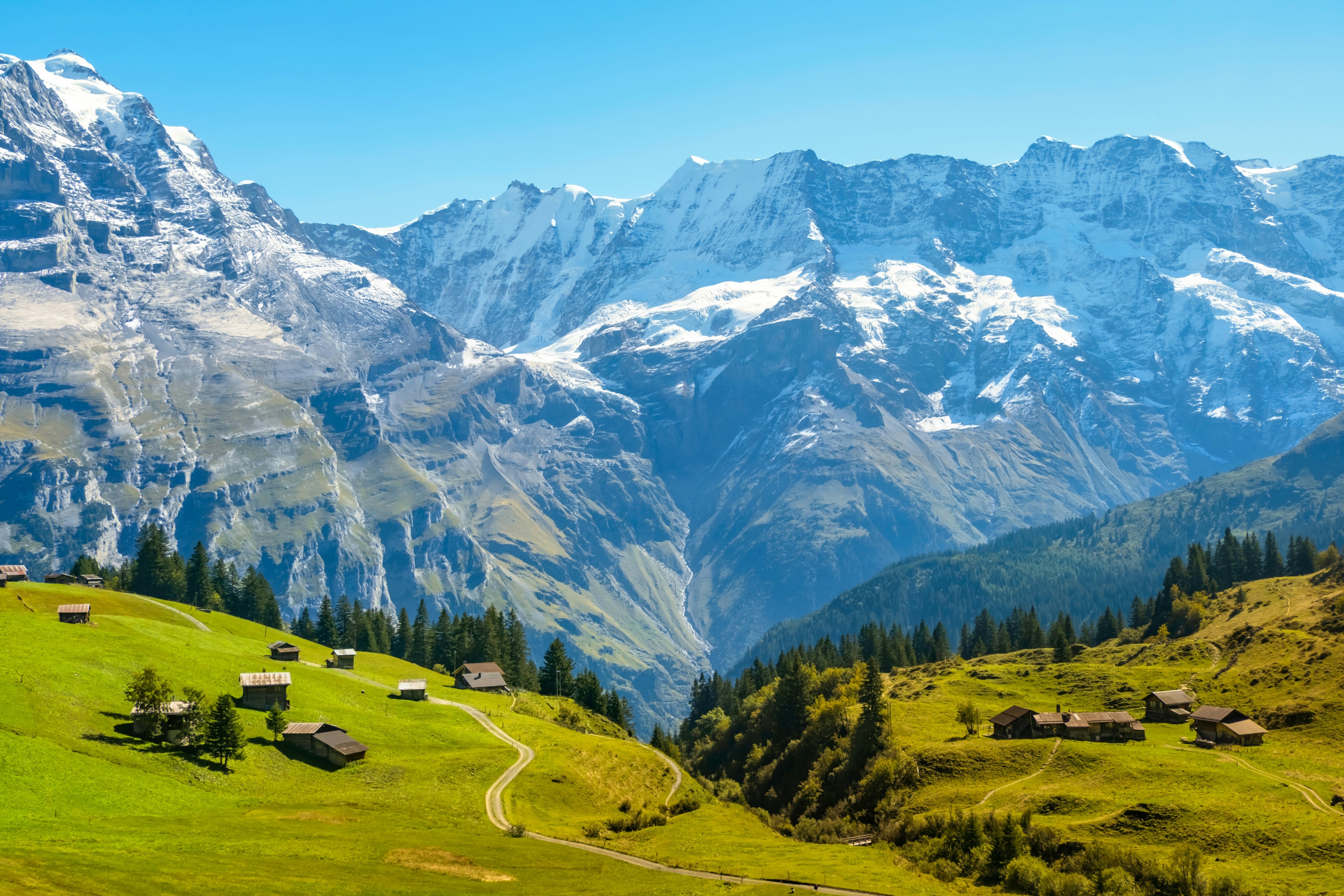 Traditional alpine village in Lauterbrunnen, with homes and trails throughout, and mountains behind