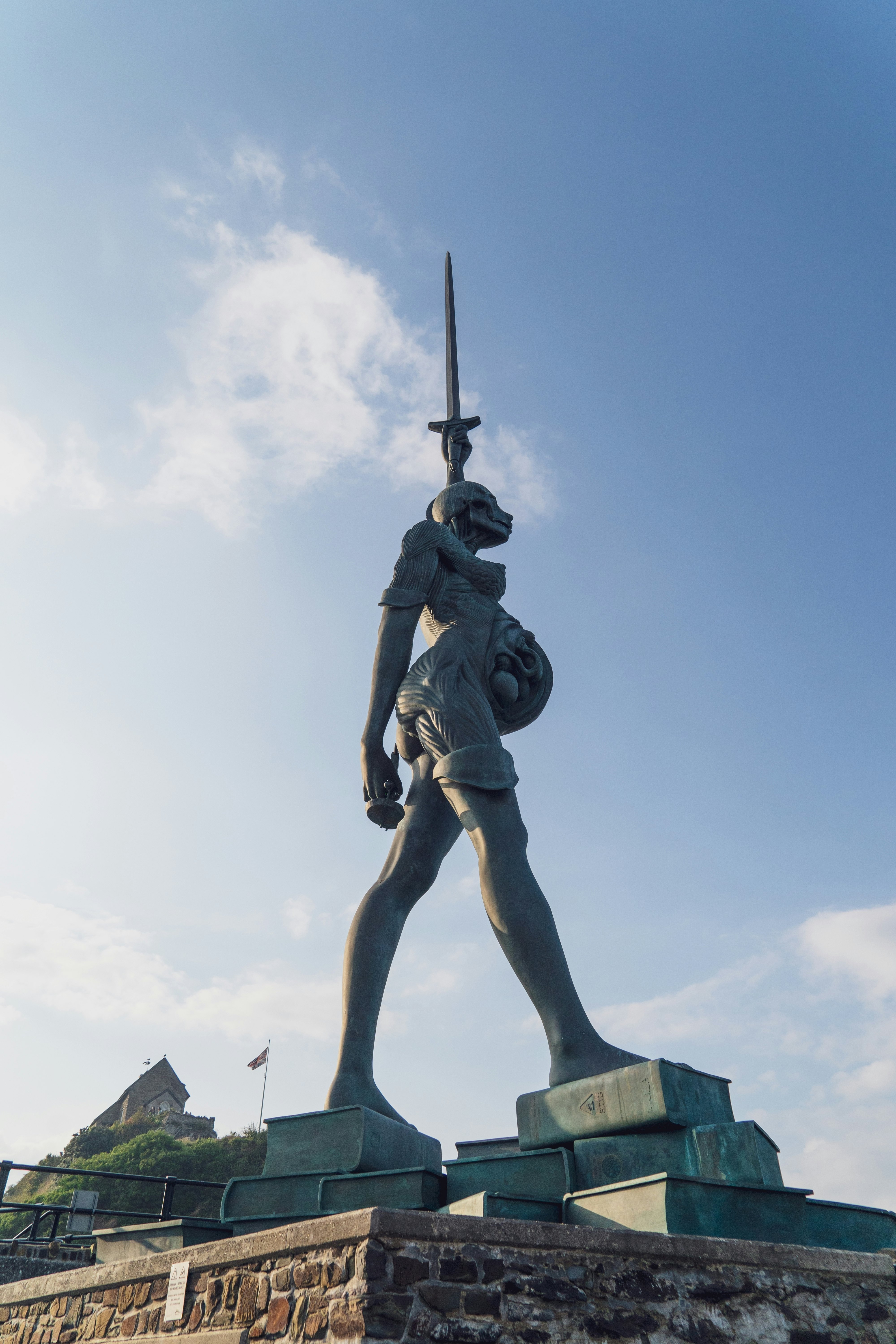 North Devon, England, UK: September 25, 2024: Ilfracombe,  - Woman sculpture at the harbour. Verity sculpture at Ilfracombe harbour, near the Chapel of St Nicholas.