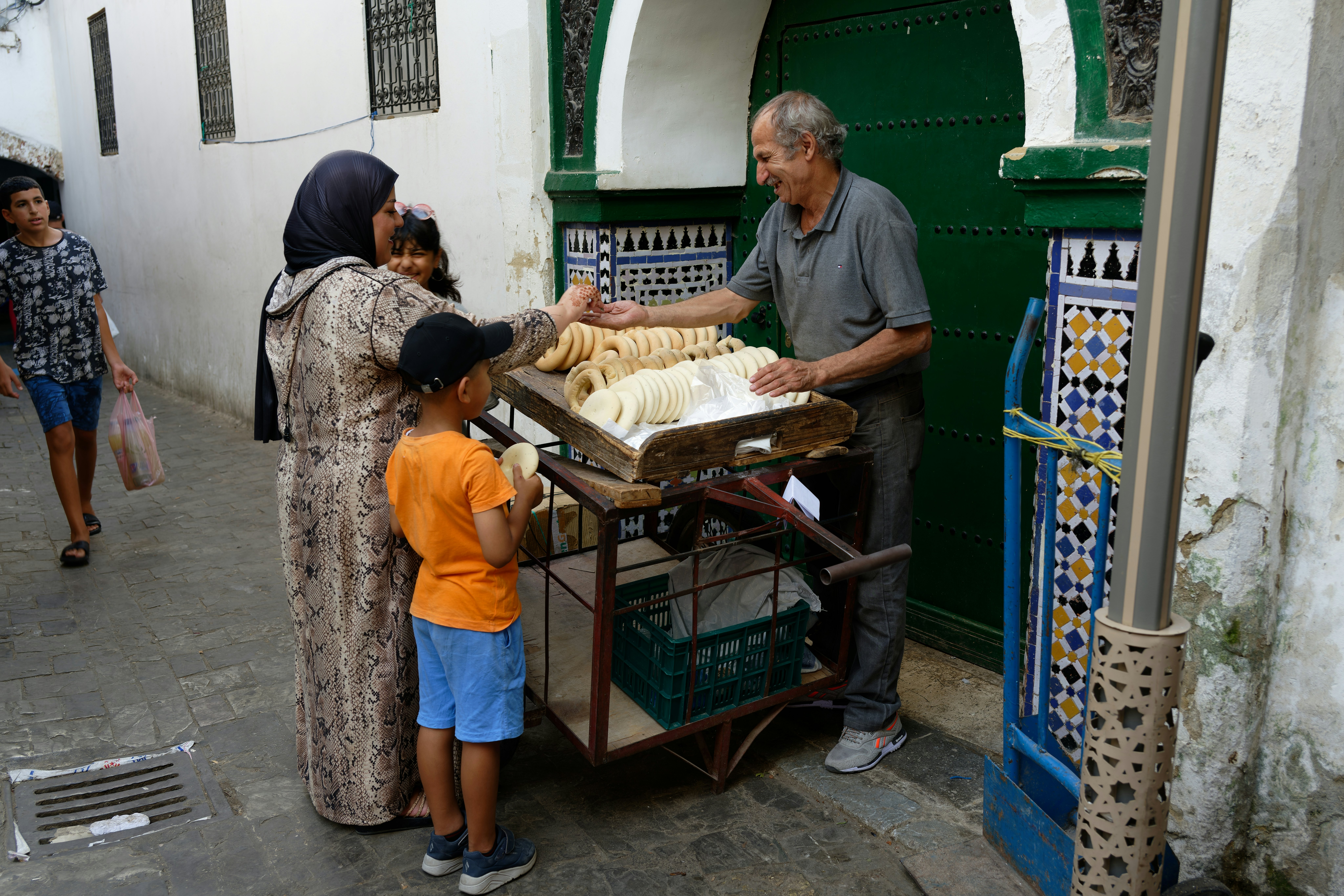 Moroccan woman buying bread in the medina in Tetouan, Morocco