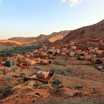 Aerial view of the Berber village of Ait Ouglif, Dades Gorges Valley in the High Atlas Mountains, Morocco at dusk. The houses, Mosque and hotels match the orange brown colour of the rugged landscape., License Type: media, Download Time: 2025-06-17T17:41:53.000Z, User: mvm_lonelyplanet, Editorial: false, purchase_order: 56530 - Guidebooks, job: Experience Morocco 1, client: Global Publishing-WIP, other: Virginia Moreno