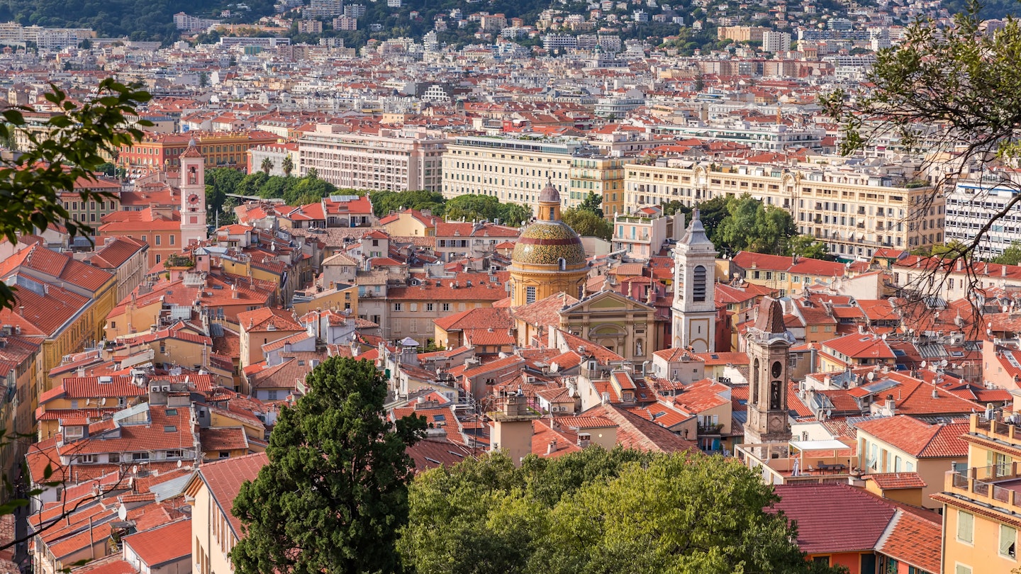 View of Nice with Old Town on a foreground among the tree branches growing on the Castle Hill at autumn sunny day, France, License Type: media, Download Time: 2025-07-28T21:40:56.000Z, User: joebindloss38, Editorial: false, purchase_order: 65050 - Digital Destinations and Articles, job: Online Editorial, client: The best free things to do in Nice, France, other: Joe Bindloss