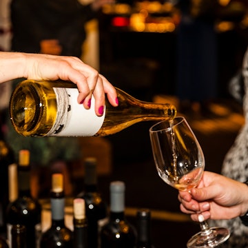 USA, Washington State, Seattle. Woman pours white wine at Northwest Women Stars of Food and Wine., License Type: media, Download Time: 2025-02-28T20:25:37.000Z, User: Ppeterson948, Editorial: false, purchase_order: 56530 - Guidebooks, job: Global Publishing WIP , client: Global Publishing WIP , other: Pia Peterson Haggarty