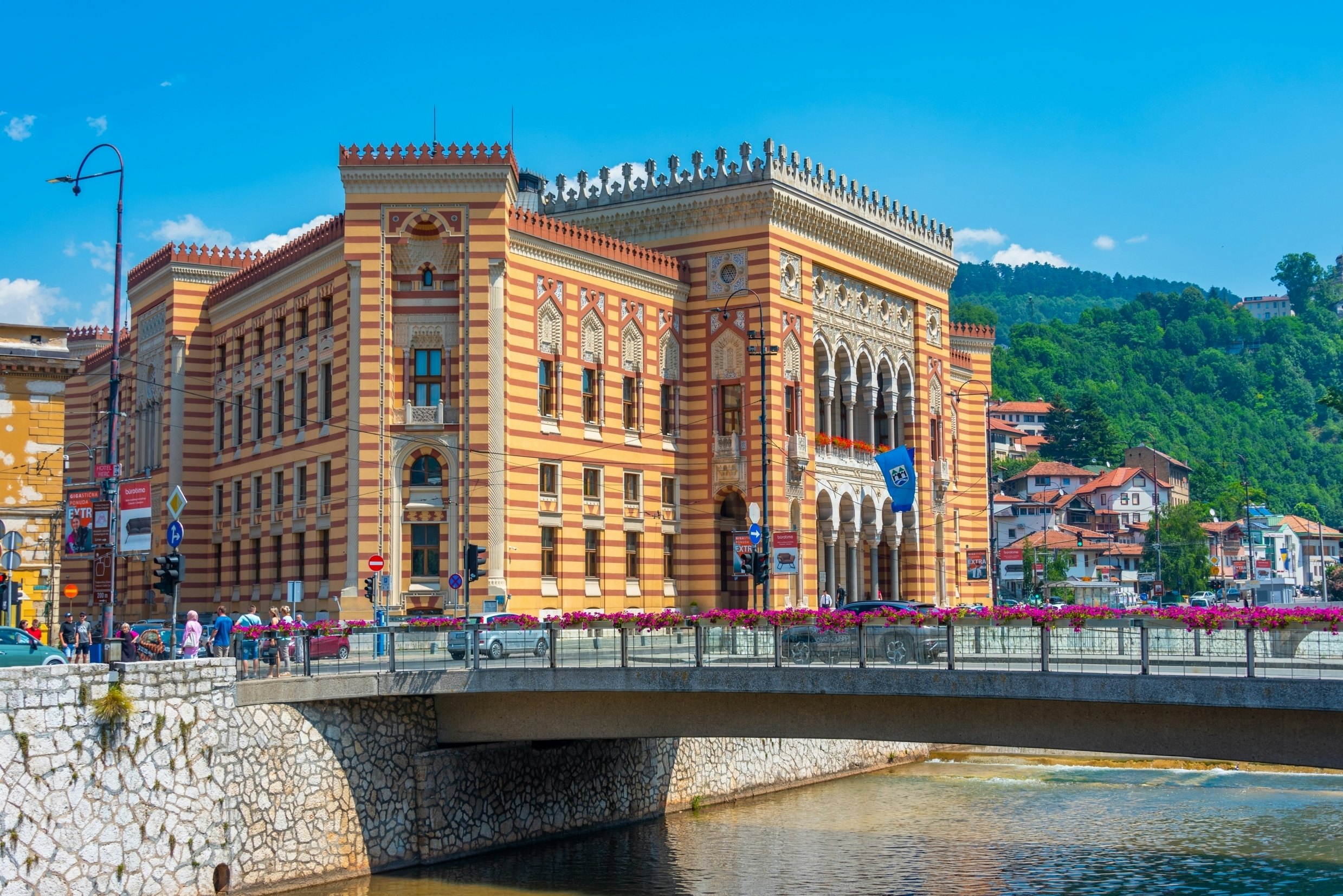 A riverside building with striped brickwork and Moorish designs over the windows.