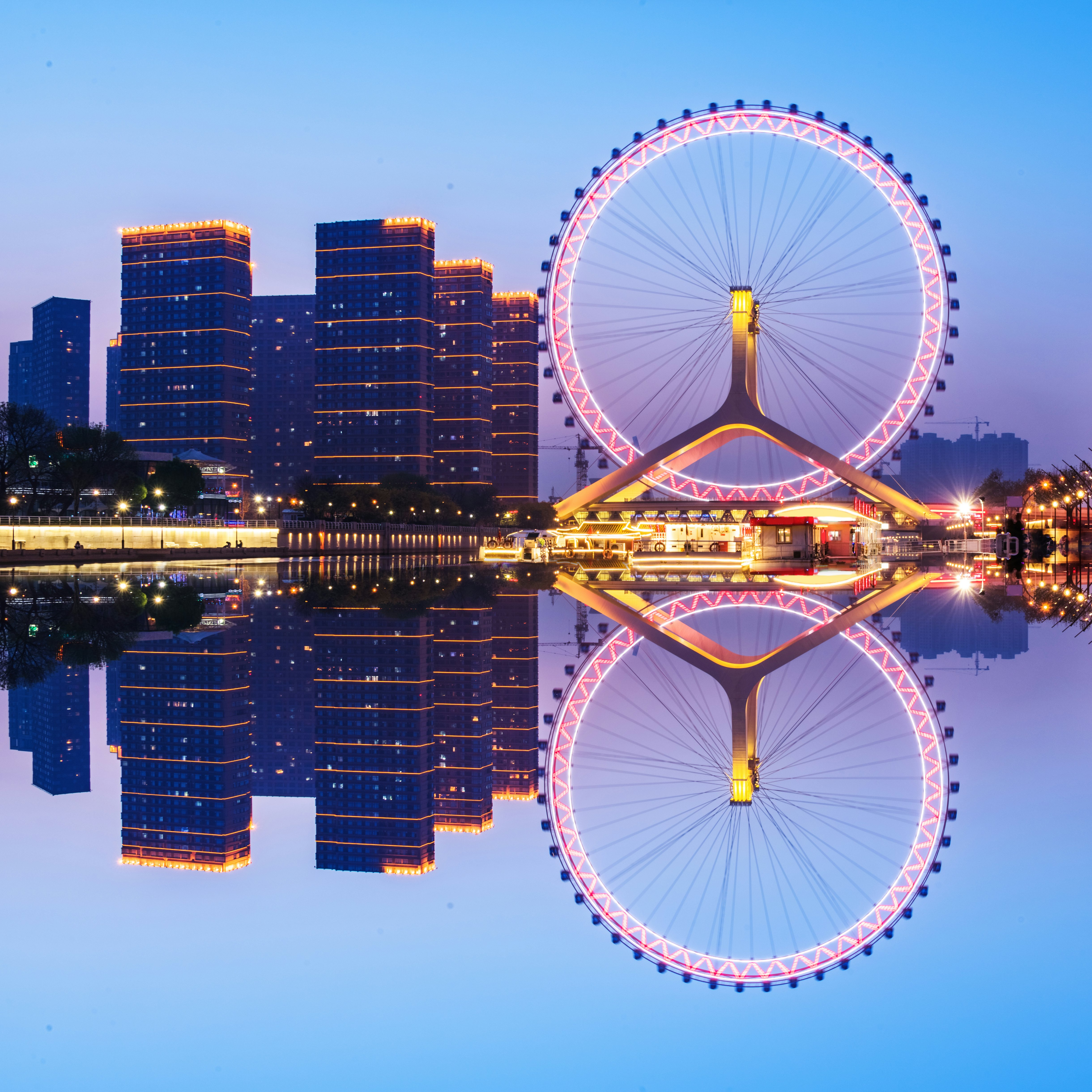 View of the Tianjin Eye reflected in the water at night in Tianjin, China.